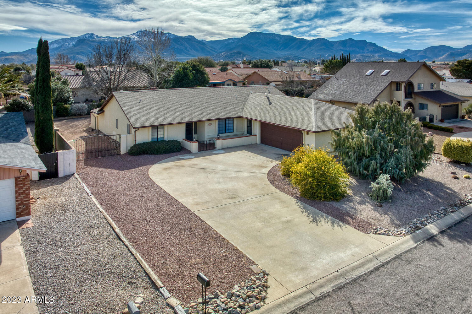 What a terrific home in a much sought after area of Sierra Vista! Ride your golf cart to the course in less than 2 minutes This 4 bedroom 2 bath home is over 2400sf  of usable living space.  Large formal dining area that opens up to the great room with gorgeous stone gas fireplace.  French doors off of the living space lead to an oversized Arizona Room perfect for entertaining.  Beautiful wood-look tile everywhere but the bedrooms.  Stunning new granite countertops in the kitchen, and a lovely kitchen nook that looks out to the well maintained backyard.  All 4 bedrooms are large and master bedroom has french doors leading to private patio with electric installed for future spa!  Enourmous master shower easily large enough for 2 people, plus 2.5 car garage is deep enough for any size vehicl