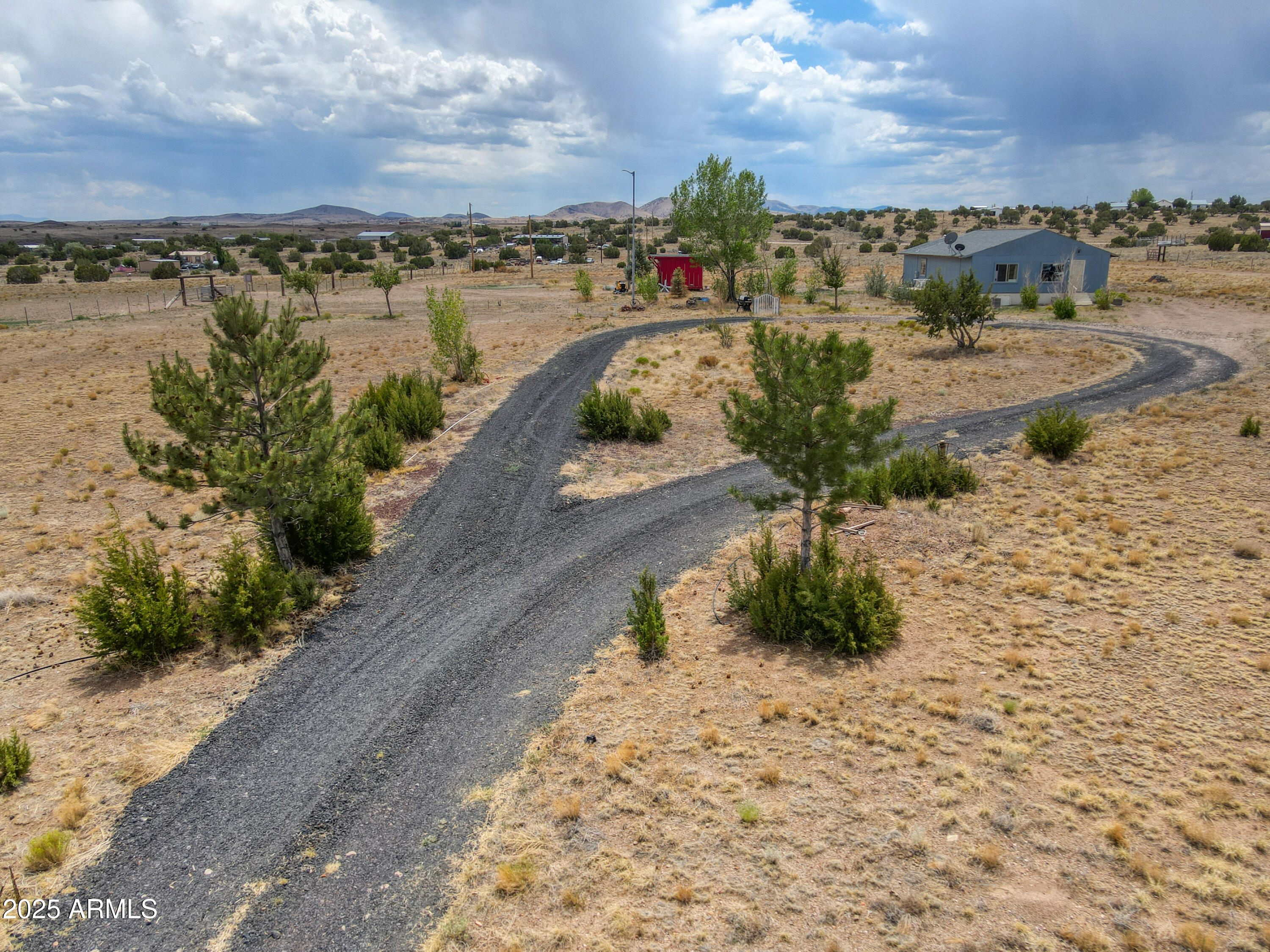 Big Sky country, REDUCED! Attractively located at the end of a gated circular driveway, this sturdy, well-loved home with outbuilding for storage or tack was built by its owner with an emphasis on practicality & lasting quality. Set on a spacious 37-acre parcel, it offers peace, privacy, & excellent views of surrounding plains & mountains in the distance. It's fully fenced & cross fenced, making it ideal for horses or livestock. Upgrades are throughout, like beautiful solid wood doors, nice flooring, & a stylish kitchen. Utilities include metered water, propane gas, & Navopache Electric plus a solar array that will be paid off at closing, keeping electric bills low for economical living! This solid, well-priced home is perfect for new owners ready to put their own finishing touches on it.