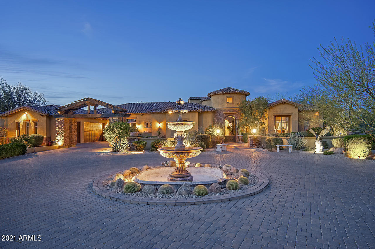 Entertainers paradise situated on over 2.5 acres for serene desert living. Private gated driveway welcomes you home to this highly upgraded estate. Designer touches throughout home including hand scraped wood inlay flooring, custom beams, canterra fireplaces, and so much more. Chef's kitchen with Viking appliances, double islands, and open layout. Master suite comes with tranquil sitting area with built in coffee for quiet mornings as you look out to the resort backyard.  The backyard has been designed for the ultimate outdoor living. Fantastic pool with water features including 10' waterfall feature with drop down movie screen. Covered living space with BBQ, teppanyaki grill, pizza oven and more. Full outdoor bar and restroom and a private oasis with hot tub and additional pergola.