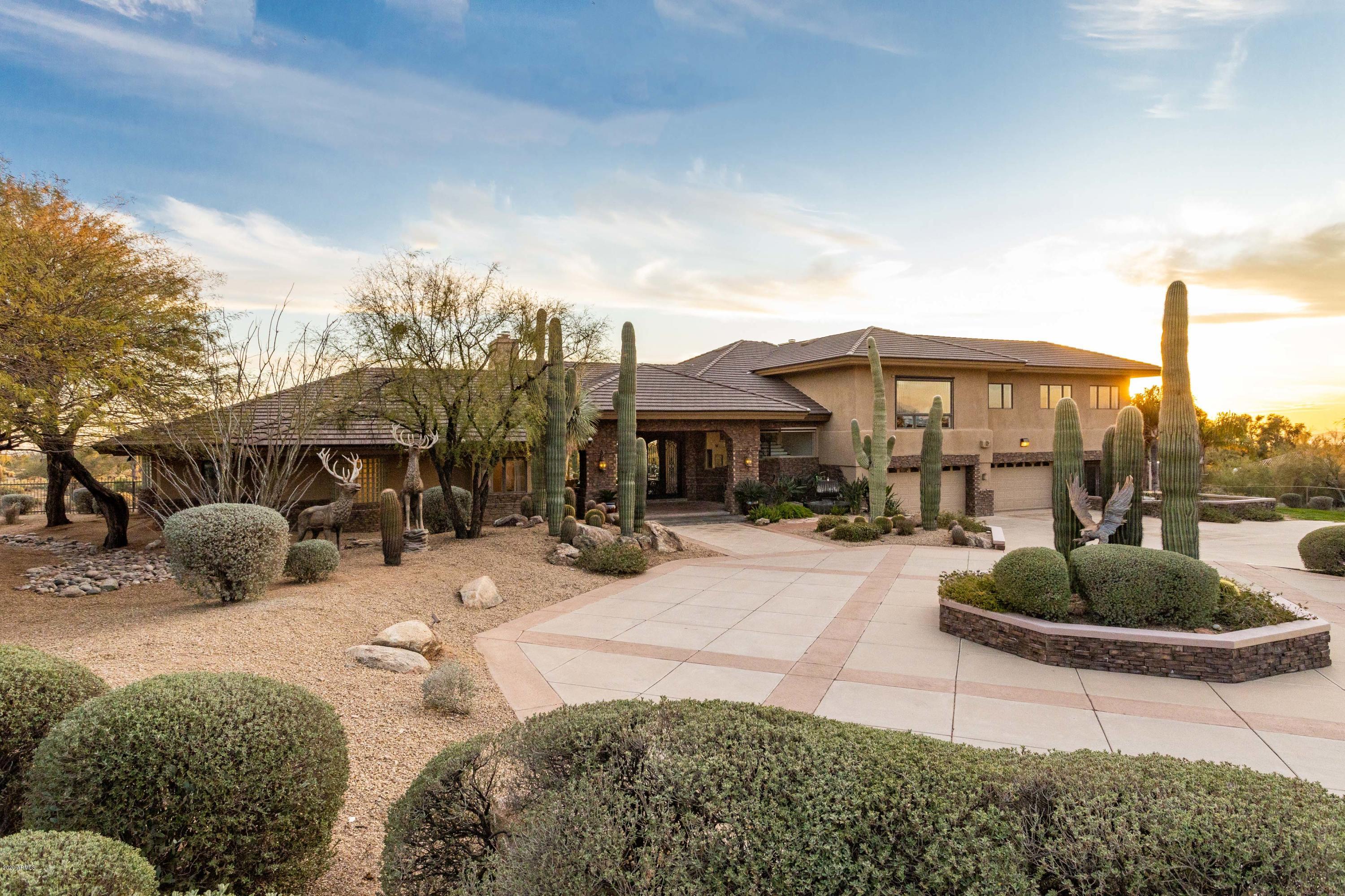 A gorgeous fully updated contemporary estate in the heart of North Scottsdale with no HOA. Sprawled out over 5 acres, this entertainers dream home exudes elegance and character with enormous vaulted beamed ceilings, solid hardwood floors, granite countertops, and custom cabinetry throughout. The kitchen features thermador appliances-including a wine fridge, oversized island, and a large farmhouse sink overlooking the backyard and mountains. The home features 2 master suites both with built in coffee bars, a wellness room, theater with built in snack station, 2 offices, all bathrooms are custom designed- the master bathroom includes a large backlit makeup vanity. The backyard has over 10,000 sq ft. of grass, a saltwater pool, spa, built-in bbq fire pit, volleyball court and two sheds.