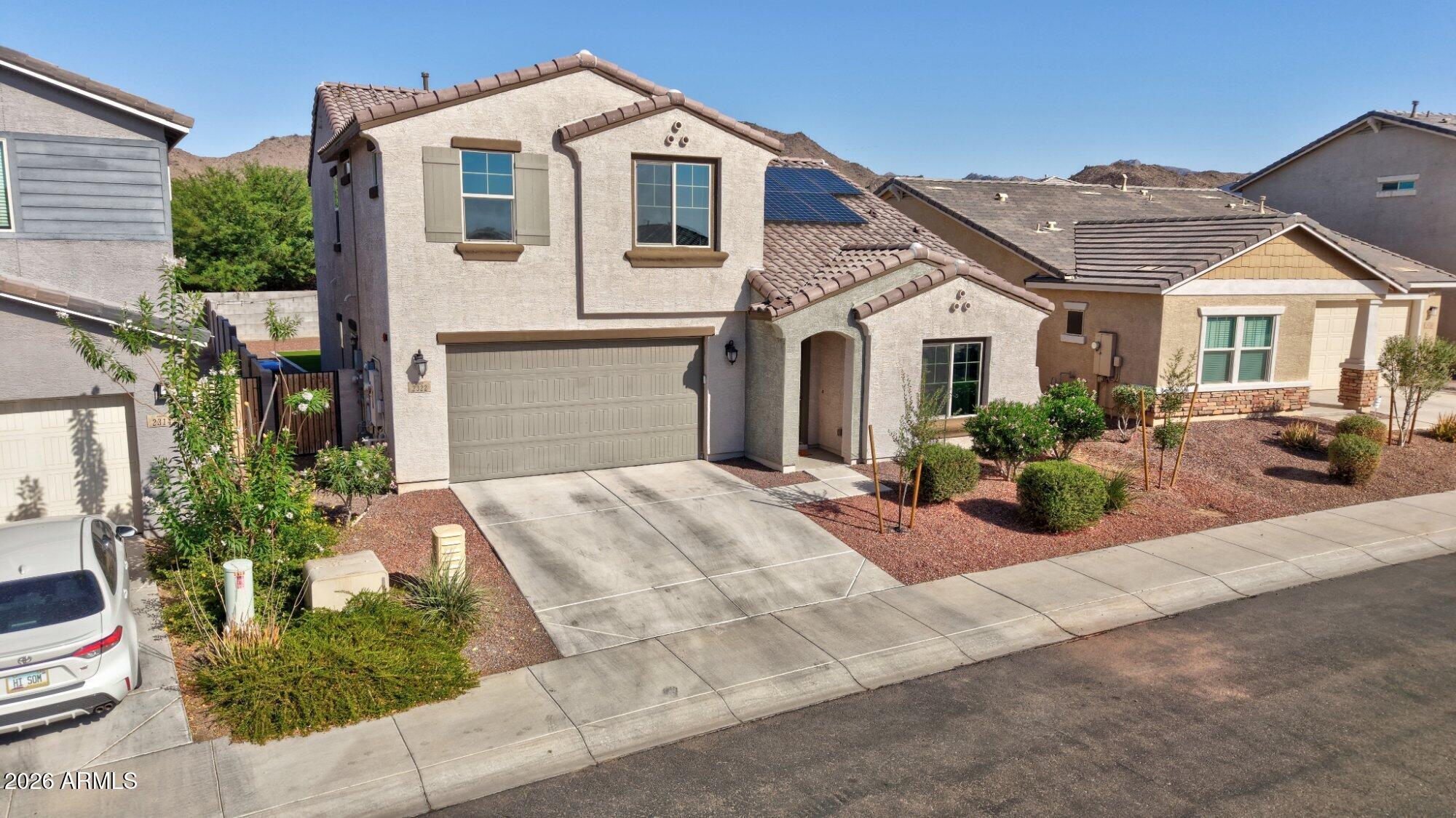 This two-story home features owned solar with recent negative power bills and a battery backup system for added efficiency and peace of mind. A 2-car garage and welcoming front porch set the tone as you arrive.
Inside, the home offers a spacious living room with two-tone paint, recessed lighting, and a blend of carpet and tile flooring. A main-floor family room adds flexible living space, along with a convenient powder room.
The modern kitchen stands out with white cabinetry accented by copper-toned hardware and faucet, a large island with breakfast bar seating, quartz countertops, and a walk-in pantry--ideal for both everyday living and entertaining.
The main-floor includes a private suite with a walk-in closet and its own bathroom, perfect for guests or multigenerational living. Upsta