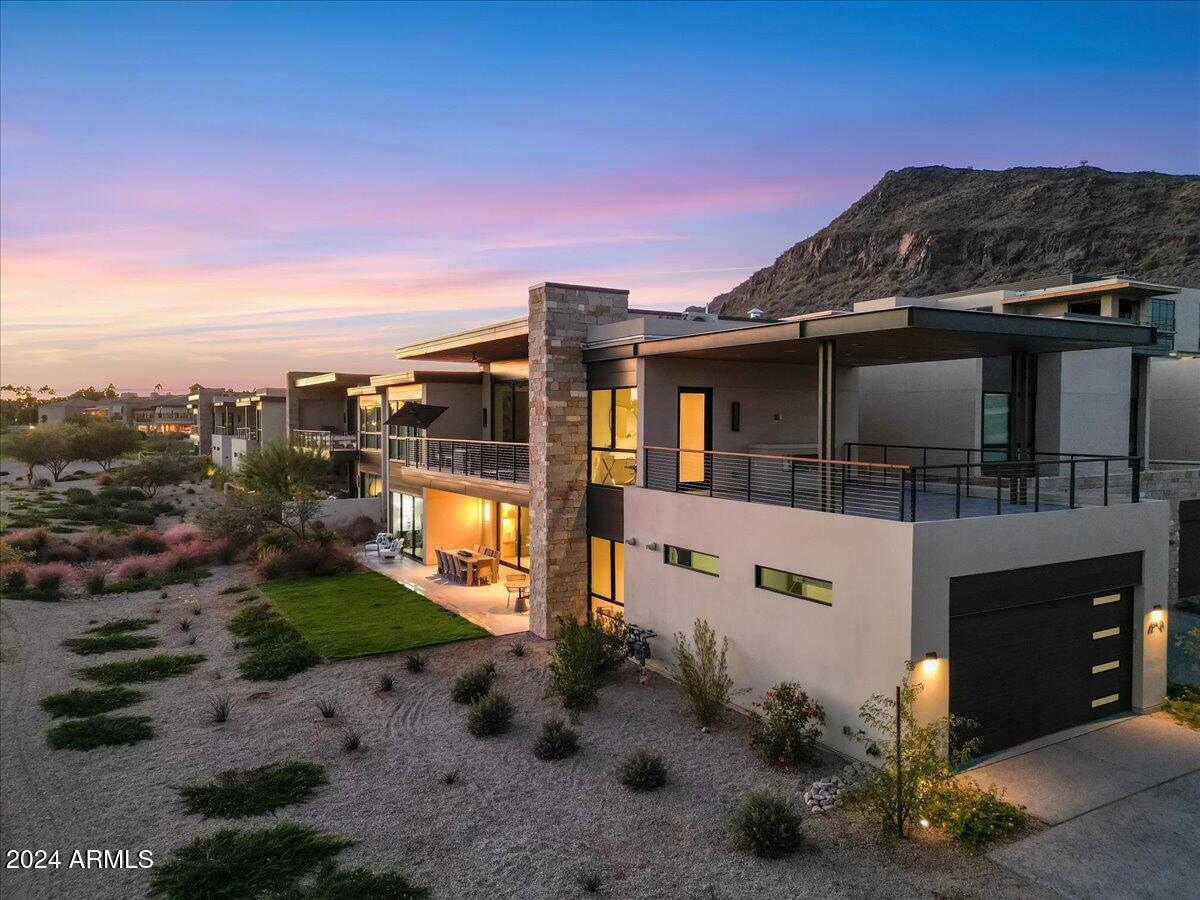 New Construction, BRAND NEW, never occupied, single level townhome sits at the base of the iconic Camelback Mountain and overlooks the Phoenician golf course. Professionally decorated with a TURN- KEY furniture package, this home is move in ready! Ascent at the Phoenician Golf Villas is a private 24/7 guard gated community situated next to the Phoenician Resort. This meticulously custom designed and upgraded 2-bed, 2.5 bath villa is truly a one of a kind. The living room boosts a Basalt stone wrapped fireplace with beautiful lighted shelves and a 288-bottle temperature-controlled wine wall. The kitchen features a Bulthaup kitchen with quartz counters and Sub Zero Wolf appliances. Wood floors and Rift oak doors throughout. Upgraded polished nickel kitchen and bath fixtures. Enjoy seamless indoor-outdoor living with custom sliding glass doors leading to a large, tiled patio with BBQ and grass yard with desert landscape. Take in the magnificent golf course views in every direction! The spacious upper-level covered terrace provides panoramic views of Camelback and Papago Mountains, along with the 1st and 9th holes on the Phoenician golf course. This Villa features 10-foot ceilings and with its modern elegance and breathtaking surroundings make it one most sought after luxury destinations in Arizona!  Included in the HOA fee is the membership to the Owners Private Mountainside Club at Accent, with Swimming Pool and Hot Tub, Full Gym, Kitchen, Pool Tables, and much more.