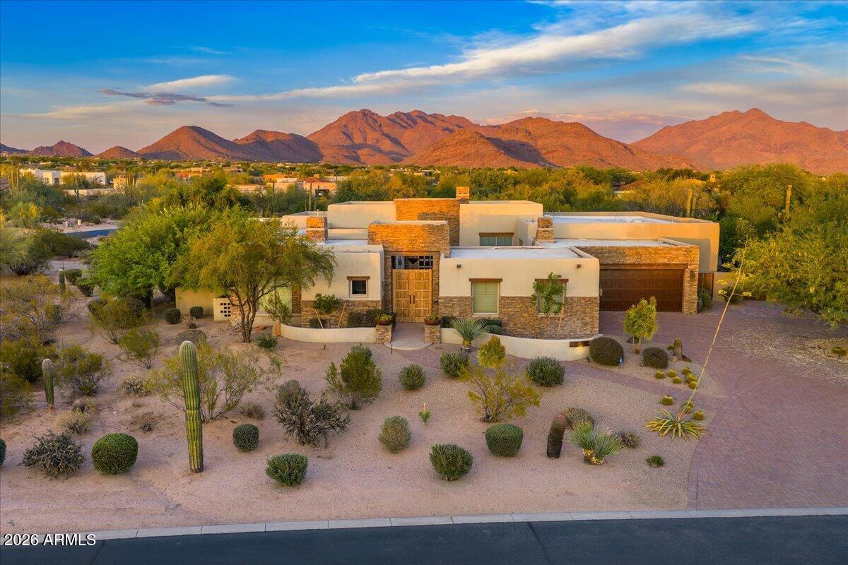 LOCATION, VIEWS AND BEAUTIFULLY REMODELED.  An amazing estate in the very desirable community of Los Gatos in the heart of North Scottsdale.  The home is situated on 1.6 acres with a resort style backyard, amazing views of the McDowell Mountains, Pinnacle Peak and privacy.   The current owners added 873 square feet to the great room and gourmet kitchen and added over 500 square feet to the covered patio.  A great home for entertaining with a bar off of the dining and great room with built in wine and beverage refrigerator. Main home has 3 ensuite bedrooms, office and flex/exercise room. Casita has living space, bedroom and kitchenette.   A beautiful resort home for indoor/outdoor living.