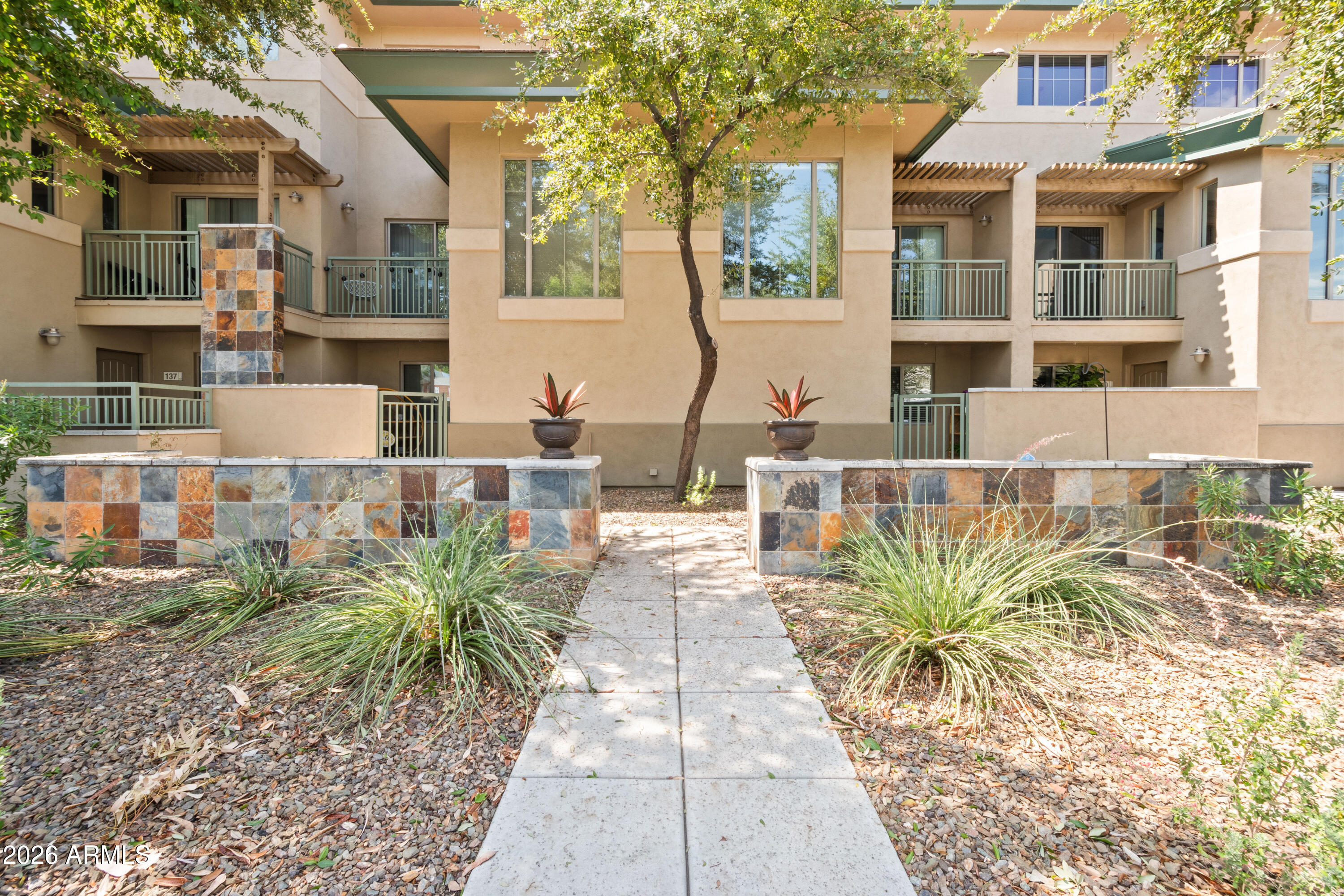 Street-facing and easy to find, this 3-level Andare townhome delivers the rare mix of privacy, access and low-maintenance North Central Phoenix living. A gated front patio opens to a flexible first-level bedroom with full bath, laundry and direct access to the 2-car garage. The main level feels open and elevated with soaring ceilings, modern blinds, two balconies and a granite kitchen with island, stainless appliances and generous storage. Upstairs, the primary suite offers a walk-in closet and updated bath with dual sinks, designer tile, soaking tub and separate shower. Enjoy Andare's community pool and spa, plus quick access to 7th Street dining, Uptown Plaza, the Camelback Corridor, AZ-51, I-17 and nearby parks.