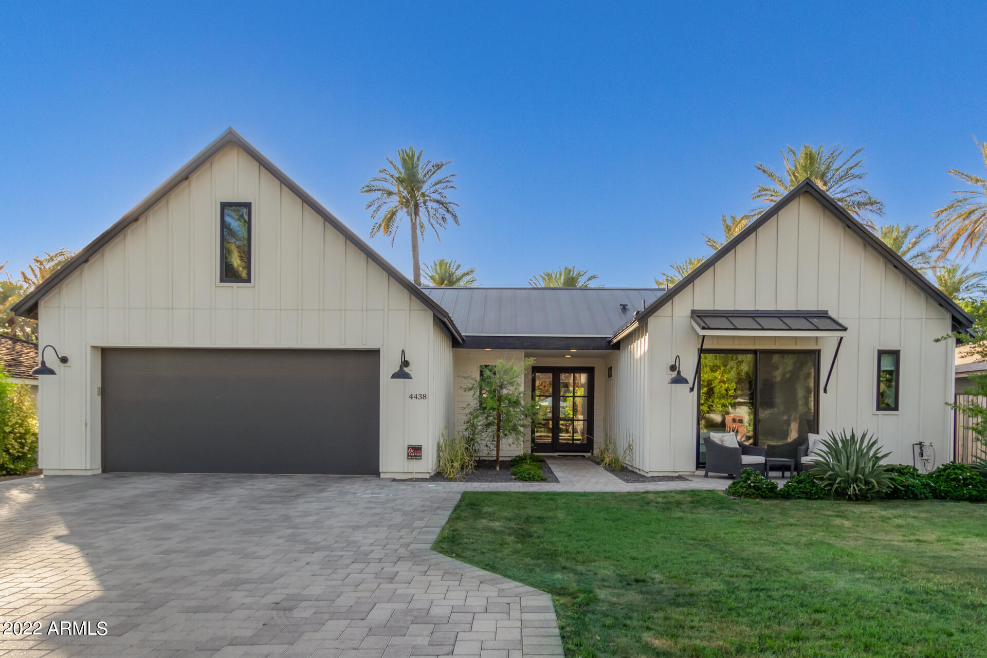 In the coveted Mountgrove ''Date Palm'' subdivision in Arcadia sits this stunning Modern Farmhouse built in 2019. Not only is the neighborhood charming and very sought after, but the home is open, welcoming and has views of Camelback Mountain. Walk into vaulted ceilings with beautiful wood beams, tons of natural lighting and designer touches wherever you look. The kitchen is perfect for entertaining and features a double island, marble countertops, SubZero and Wolf appliances. The split floor plan includes a spacious primary suite and a dream bathroom and extensive closet. The guest wing features a bonus room, which is perfect as a media room, playroom or office. Two additional rooms are connected by a ''jack and jill'' bathroom, and and additional guest suite opens to the front patio. The backyard has recently been upgraded to add a saltwater, heated pool with a spa, a built-in Lynx Grill, which is next to a covered patio and a separate pergola, great for hosting! There is epoxy coated floors and built-in cabinets for optimal storage in the garage and is wired for smart home technology. This home is in the Hopi School district and a short walk to Henry, OHSO, Buck and Rider and all of Arcadia's favorite spots! A MUST SEE!