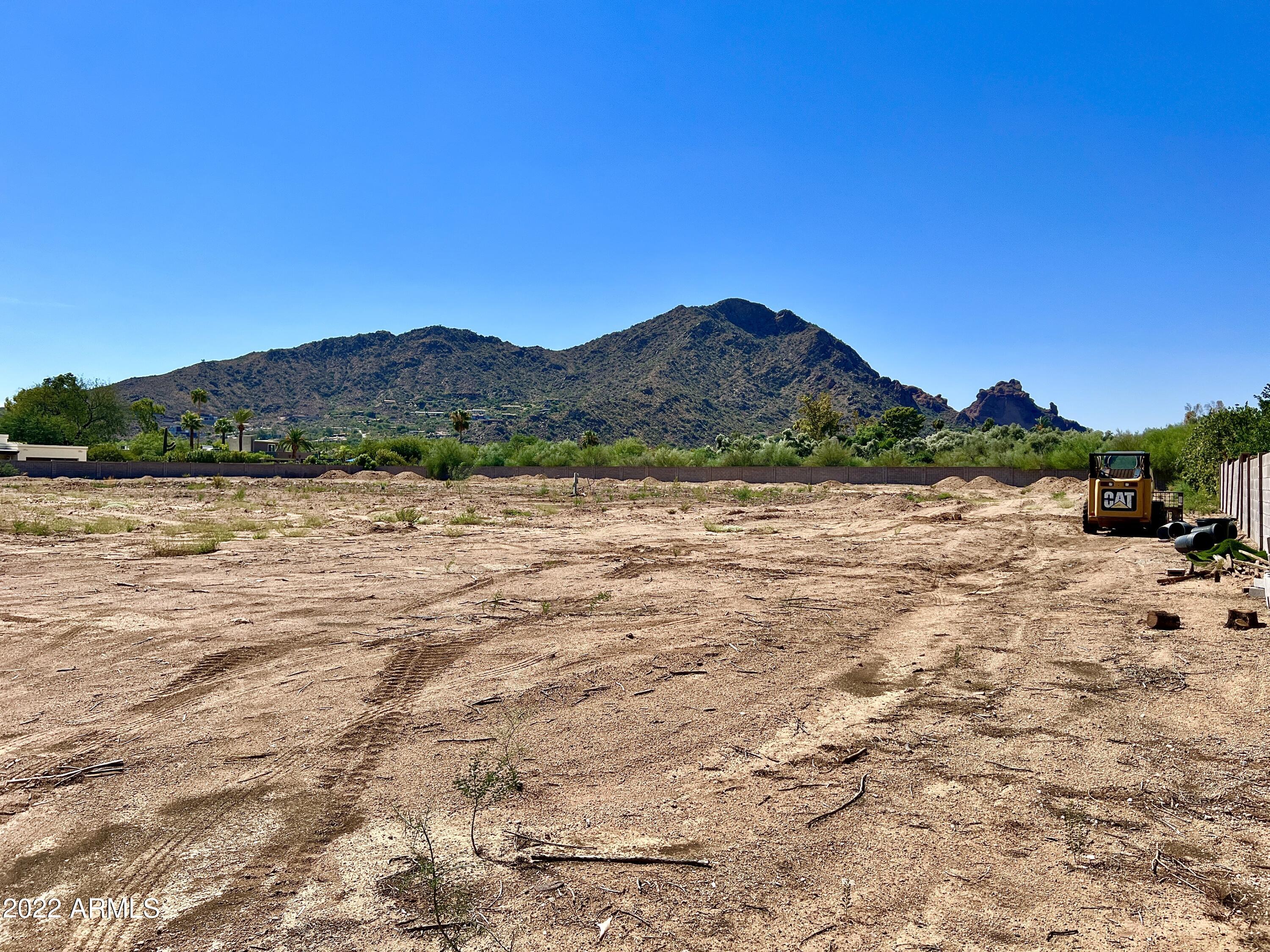 Once in a lifetime opportunity to own 2.5 Acres with Incredible Camelback Mountain Views in the Heart of Paradise Valley! Drive down your private flag lot to your flat, secluded, stately rectangular lot and build the estate of your dreams!  The land offers tremendous privacy and security with a 300 foot driveway, block wall around the perimeter of the property, and gated entrance. Conveniently located near the new Ritz Carlton, Sanctuary Resort, Paradise Valley Country Club and the finest shopping, dining and entertainment.