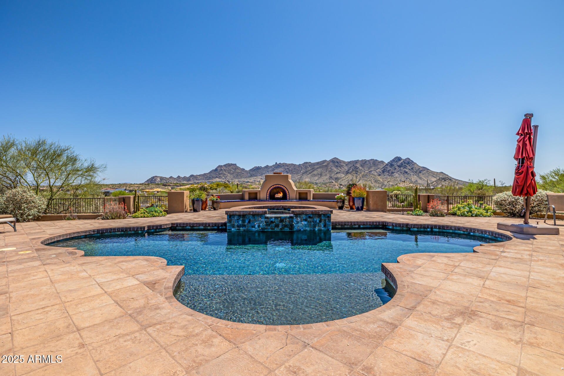 Unmatched Privacy • Pristine Condition • Panoramic Desert & Mountain Views
Perched on 3.78 serene acres with commanding 360° mountain and city-light views, this custom-built Tuscan estate offers the rare combination of timeless craftsmanship, immaculate condition, and breathtaking scenery from every room.
Thoughtfully designed across 4,351 sq ft, the home showcases dramatic beamed ceilings, hand-laid stonework, and walls of glass that frame sunrise-to-sunset vistas. The chef's kitchen features a professional-grade range beneath a striking copper hood, with seamless flow into open living spaces that capture the surrounding peaks.
Resort-inspired outdoor living includes a sparkling pool and spa perfectly positioned for sunset views, expansive patios for entertaining, and a pavered gated drive ensuring privacy and arrival impact. Car collectors will appreciate two garages accommodating 4-8 vehiclesincluding a professional-grade liftwhile owned solar power offers sustainable efficiency. Meticulously maintained and move-in ready, this property combines elegance, functionality, and iconic Sonoran Desert scenerya true legacy estate for those who demand extraordinary quality and endless views.