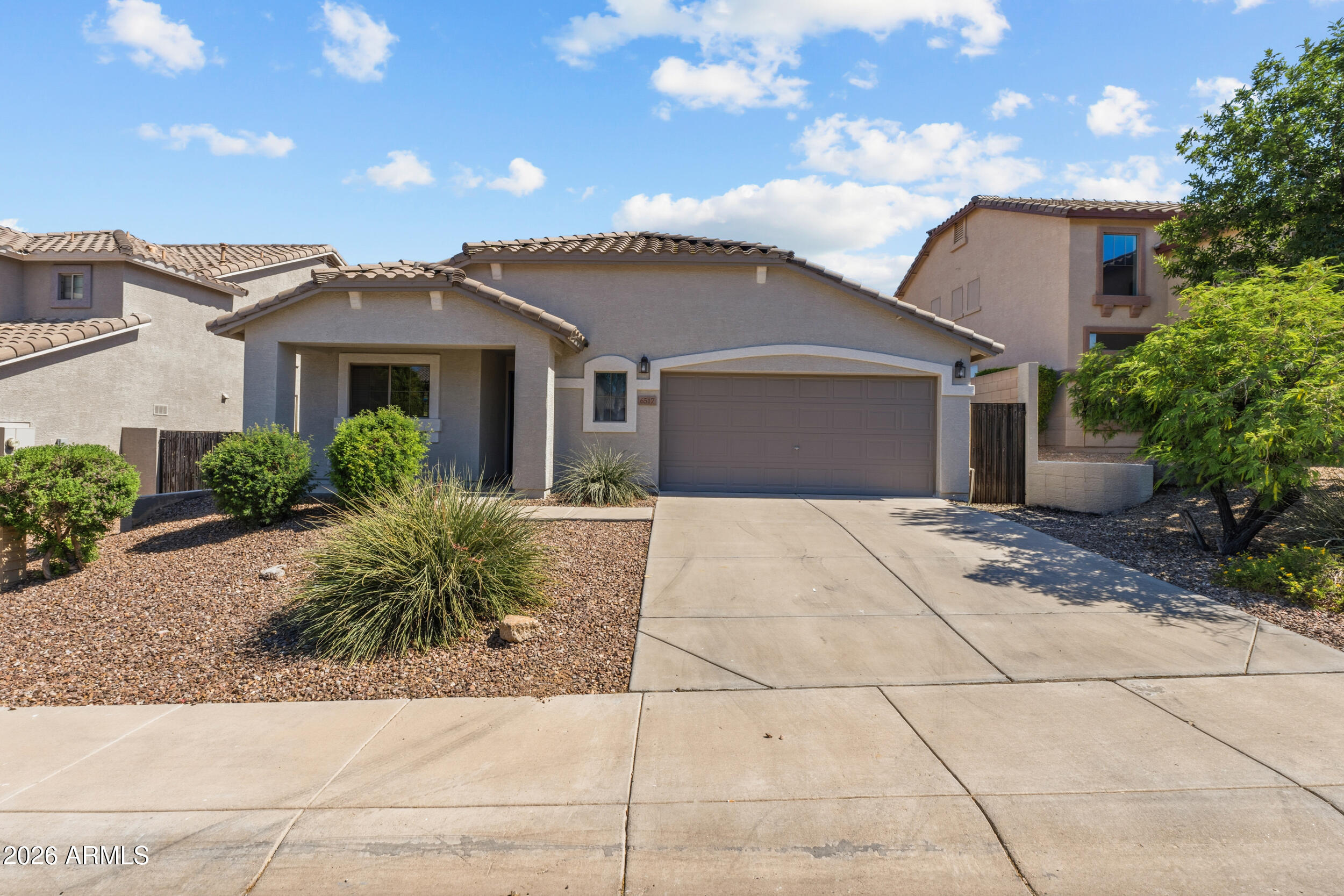 Beautifully maintained single-level home offers 3-bedroom, 2-bath with a bonus office room. Inside features tile flooring throughout the main living areas, and an inviting living room with an entertainment cove. The spacious primary suite includes a large walk-in closet, dual vanities, tub/shower combo, additional built in cabinets, and separate toilet room. The additional 2 bedrooms share a convenient Jack-and-Jill bath with its own linen closet. Enjoy mountain views from the covered concrete patio complete with a ceiling fan, plus a backyard featuring real grass with sprinklers and low-maintenance landscaping. A charming front porch seating area and spacious 2 1/2-car garage complete the home. Conveniently located near hiking, biking, golf, shopping, dining, Loop 101, 303, I-17, and Lake Pleasant, this home offers the perfect combination of tranquility, lifestyle, and location.