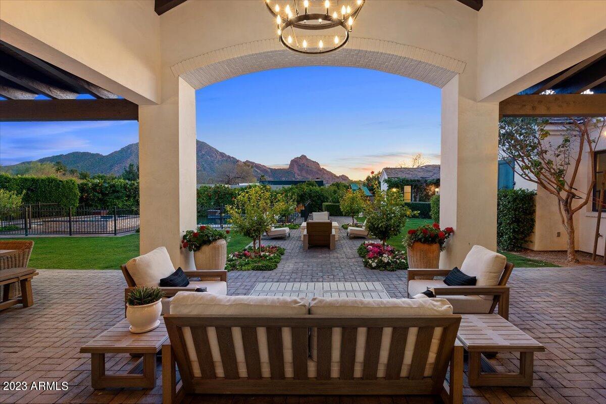 Privacy and perfection define this custom-built luxury residence masterfully imagined by world-renowned architect Mark Candelaria, in collaboration with Donna Vallone Interiors. Nestled at the end of a signature cul-de-sac on one of the most private 1 acre lots in Paradise Valley, and sandwiched between Camelback and Mummy mountains, this timelessly designed residence captures commanding views from every room. An open single-level floor plan that is light and bright, comfortable yet sophisticated, seamlessly blends the best of Arizona indoor/outdoor luxury living. Inviting entertaining spaces and courtyards fully open to a picturesque resort backyard with panoramic head to tail views of Camelback Mountain. Highest quality of construction throughout, See More & MOTION VIDEO! incorporating the best materials like Gandoff marble, Calcutta marble, Tabarka tile, wood flooring layout, Highend cabinetry, Clyde hardware, imported clay paver roof, Redlands clay brick accents, all reimagined to exude authentic upscale casual-comfort. The main residence has 4 en suite bedrooms, plus a detached guest house with kitchen, main living space, and separate bedroom, ensuring you and your guests will always feel comfortable. This luxury residence is great for those seeking ideal square footage and low maintenance living. We welcome you to schedule a preview and explore this rare opportunity to acquire a truly special property in one of Paradise Valley's most exclusive, established and coveted locations.