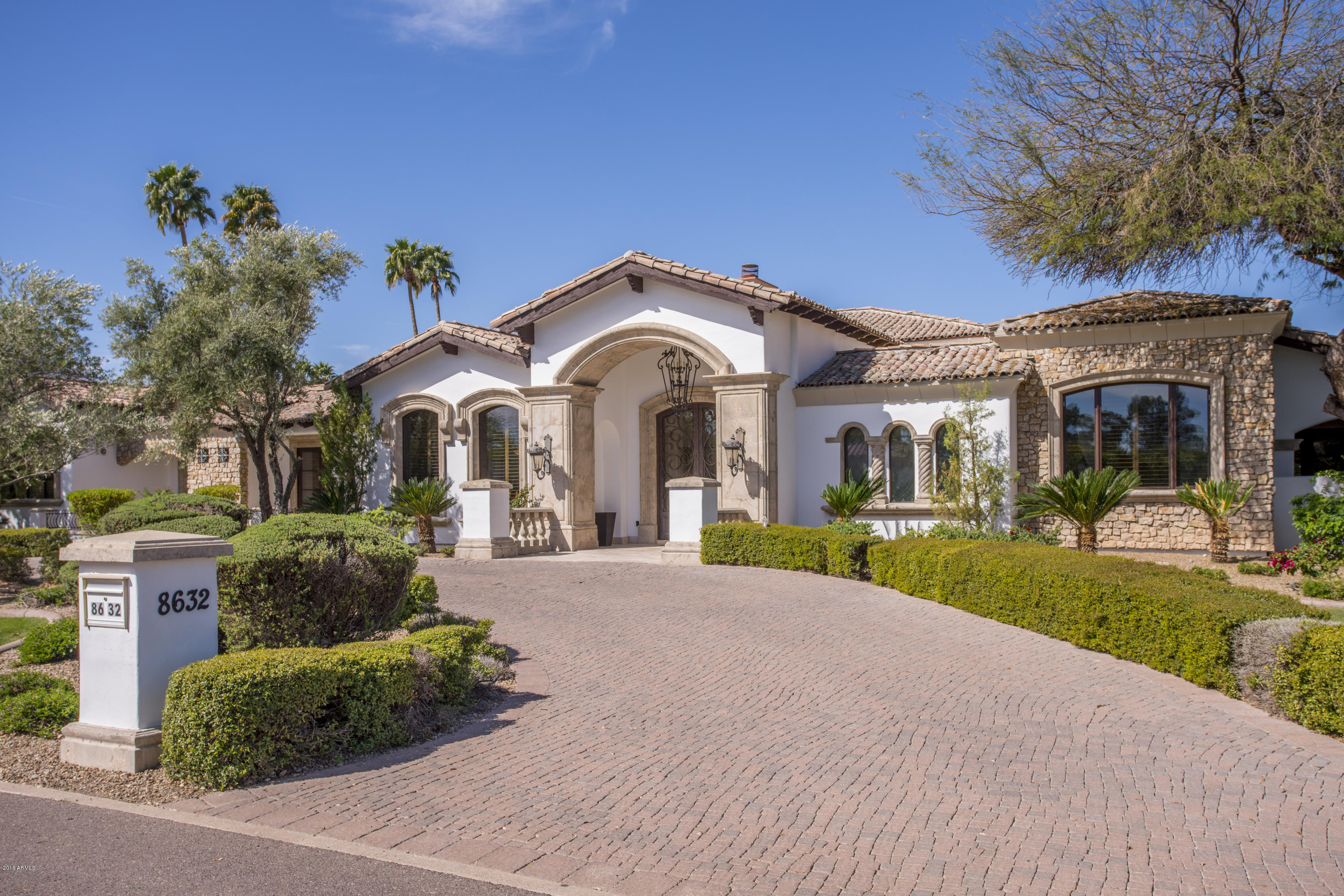 Updated Santa Barbara Custom Home in the heart of Paradise Valley! This open and spacious floor plan provides ultimate in indoor & outdoor living and is perfect for entertaining. The home boasts imported stone and custom crafted cabinetry throughout. The grand gourmet kitchen features a custom brick ceiling, granite countertops and high end built-in appliances. The Family room, eating area, office and multiple bedrooms all lead to the expansive yard with a stunning pool & spa with water features, private patios, separate Ramada, outdoor kitchen & shower, 2 fire pits and boccie ball court. These features make it the ultimate outdoor living home! The massive split master suite has a separate sitting area, his and her closets, as well as a steam shower, Jacuzzi tub, and gym room!