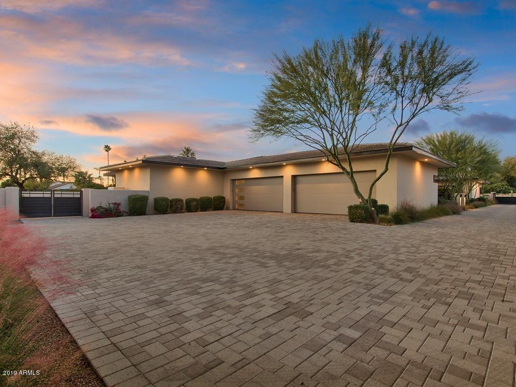 LOCATED IN THE HEART OF PARADISE VALLEY IN THE LUXURY COMMUNITY OF 7M RANCH ESTATES IS THIS 4 BEDROOM PLUS A DEN, 4.5 BATHROOM, CONTEMPORARY-STYLE ESTATE HOME! HOME WAS BUILT OUT OF ICF POURED INSULATED CONCRETE FOUNDATIONS MAKING IT EXTREMELY ENERGY EFFICIENT AND VERY QUIET. VRV DAIKEN AC SYSTEM WITH EVERY ROOM INDIVIDUALLY ZONED. HOUSE IS SET UP AS A SMART HOME WITH A FULLY AUTOMATED SAVANT PRO SMART HOME SYSTEM TO CONTROL ENTIRE HOME. PRIVATELY GATED RESIDENCE WITH ALL COMPLETELY PAVERED DRIVEWAY AND AUTO COURT ALONG WITH A FIVE-CAR GARAGE. TOTAL OF 4 MOTORIZED POCKET DOORS TO CREATE THE ULTIMATE INDOOR/OUTDOOR LIVING WITH CUSTOM ELECTRONIC SCREENS.  GATED ENTRANCE WITH A WATERFALL FOUNTAIN IN THE FRONT COURTYARD AREA. STONE TILE WALK-WAY UP TO THE ENTRANCE OF THE HOME. OVERSIZED GREAT ROOM WITH A DUAL-SIDED ELECTRIC FIREPLACE. PRIVATE OFFICE AREA WITH CUSTOM BUILT-INS, SEPARATE EXIT AND SEATING AREA - CAN ALSO BE CONVERTED TO A FIFTH BEDROOM IF NEEDED.  POWDER ROOM JUST OUTSIDE THE OFFICE. SPLIT FLOOR PLAN. LOUNGE AREA JUST OUTSIDE THE TWO GUEST BEDROOMS. BOTH GUEST BEDROOMS HAVE A FULL EN-SUITE BATH AND WALK-IN CLOSETS. BEAUTIFUL CHEF'S DREAM KITCHEN WITH EVERYTHING YOU COULD WANT IN A KITCHEN AREA. LARGE KITCHEN ISLAND WITH EAT-UP BAR SITTING AREA AND FARMHOUSE STYLE DEEP SINK. ALL WOLF STAINLESS STEEL APPLIANCES INCLUDING SUB-ZERO FRIDGE AND FREEZER, 4-BURNER GAS RANGE WITH MIDDLE GRIDDLE, STEAMER OVEN. WALK-IN PANTRY WITH A CUSTOM COSTCO FRIDGE! FORMAL DINING AREA WITH A WET BAR. FULL SIZE WINE FRIDGE INCLUDED! SPACIOUS LAUNDRY WITH LOTS OF STORAGE SPACE. MASTER BEDROOM TAKES UP THE END OF THE HOUSE WITH ITS OWN FITNESS AREA AND DUAL DOOR EXITS OUT TO YOUR PRIVATE PATIO AREA. SEPARATE SINK VANITIES IN THE MASTER BATH, ALONG WITH A FREE-STANDING SOAKING TUB AND DUAL-SIDED WALK-IN SHOWER. ENJOY SOME ROMANTIC AMBIANCE WITH YOUR OWN OUTDOOR FIREPLACE AND FOUNTAIN.  EXTENDED COVERED PATIO AREA WITH A BUILT-IN FIREPLACE, LOTS OF SEATING AREA, AND FULL BUILT-IN BBQ COOKING AREA. EVEN A SIT UP BUFFET WINDOW FROM THE KITCHEN AREA TO THE PATIO. LUSH GRASS LANDSCAPING WITH A MIXTURE OF DESERT TREES IN THE BACK YARD. PRIVATE POOL WITH WATERFALL FEATURES AND SPLASH PAD ON THE SIDE. SEPARATE GUEST HOUSE WITH BUILT-IN KITCHENETTE AREA TO INCLUDE MINI-FRIDGE, MICROWAVE, COOKTOP, DISHWASHER, STACKABLE WASHER & DRYER.  FULL-SIZE BATH AND WALK-IN CLOSET ALONG WITH A SMALL DINING AREA. GUEST HOUSE ALSO HAS A SINGLE-CAR GARAGE ATTACHED TO IT. THIS PRIVATE ESTATE HOMES OFFERS CONVENIENT ACCESS TO ALL PARTS OF THE VALLEY, TUCKED WITHIN A SERENE AND UNCLUTTERED SONORAN DESERT SETTING.