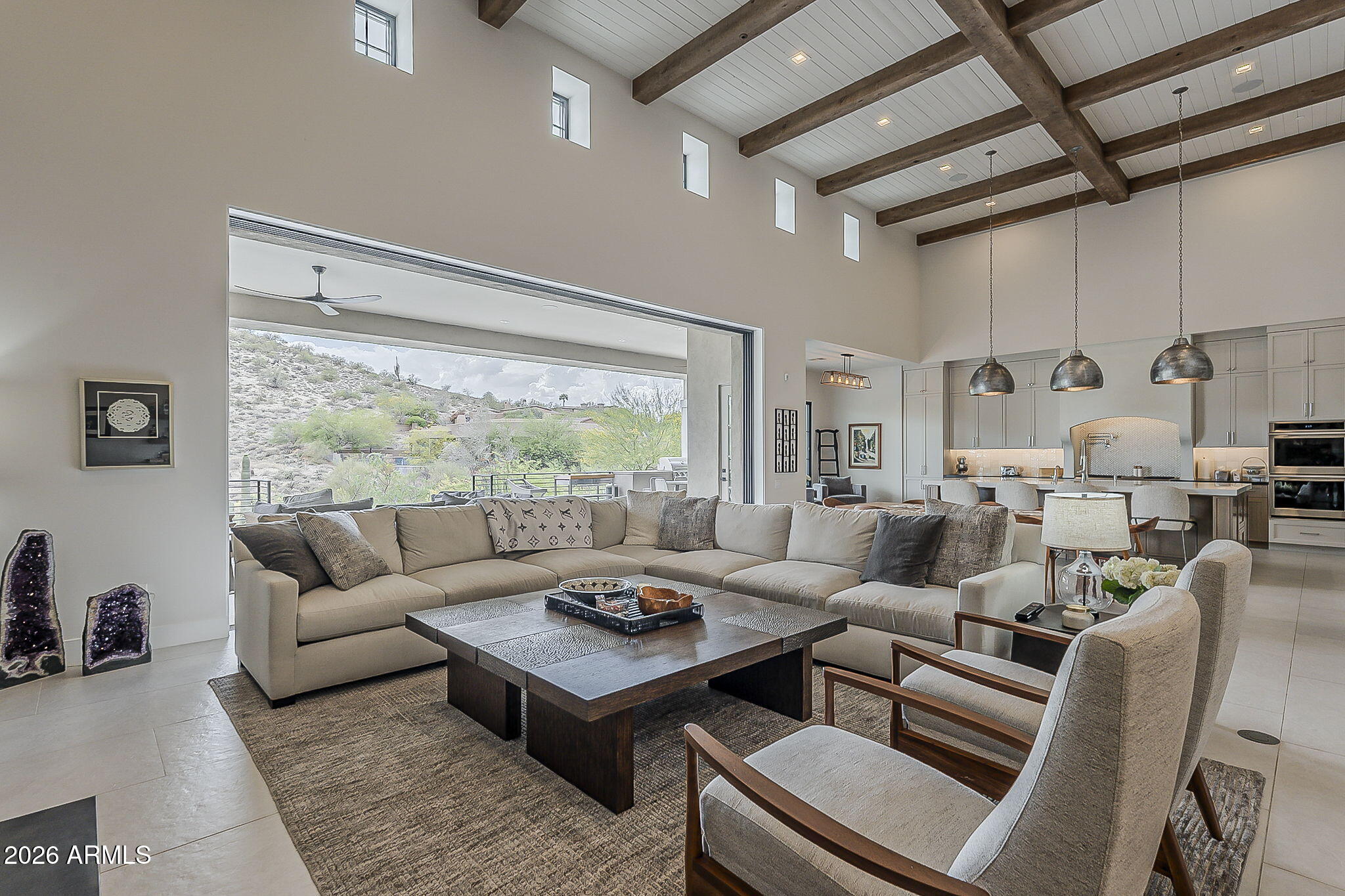 Perched in an elevated gated enclave, this Scottsdale-caliber private-view estate offers a rare combination of refined desert luxury, resort-style indoor-outdoor living, and sweeping mountain vistas--paired with a level of privacy and space increasingly difficult to replicate in comparable luxury markets.

Designed to maximize its elevated positioning, the residence captures uninterrupted desert and mountain views from primary living spaces, creating a seamless connection between architecture and landscape. Expansive glass walls open to a resort-scale outdoor environment featuring a pool, spa, and multiple lounge areas oriented toward dramatic natural scenery.

The home is offered fully enhanced with select furnishings included in the sale, creating a turnkey luxury experience! Offering immediate enjoyment or second-home use. This inclusion represents a meaningful value advantage at the current pricing position, allowing the property to be experienced as a fully realized designer residence from day one.

A completed pre-listing inspection provides added confidence and transparency, significantly reducing buyer uncertainty and streamlining the path to ownership in today's selective luxury market.

Inside, the open-concept design emphasizes scale, light, and flow, with a chef-inspired kitchen at the heart of the home and thoughtfully designed living spaces that transition effortlessly between indoor and outdoor living. The primary suite serves as a private retreat with view orientation and spa-like amenities, while secondary bedrooms offer generous accommodations for guests or multi-generational living.

Set within a quiet, low-density luxury corridor, this estate delivers a rare balance of Scottsdale-level design, elevated desert tranquility, and turnkey readiness--all at a positioning that reflects both the included furnishings and recent market alignment.

This is not simply a home--it is a fully prepared private desert-view estate designed for immediate luxury living without compromise.