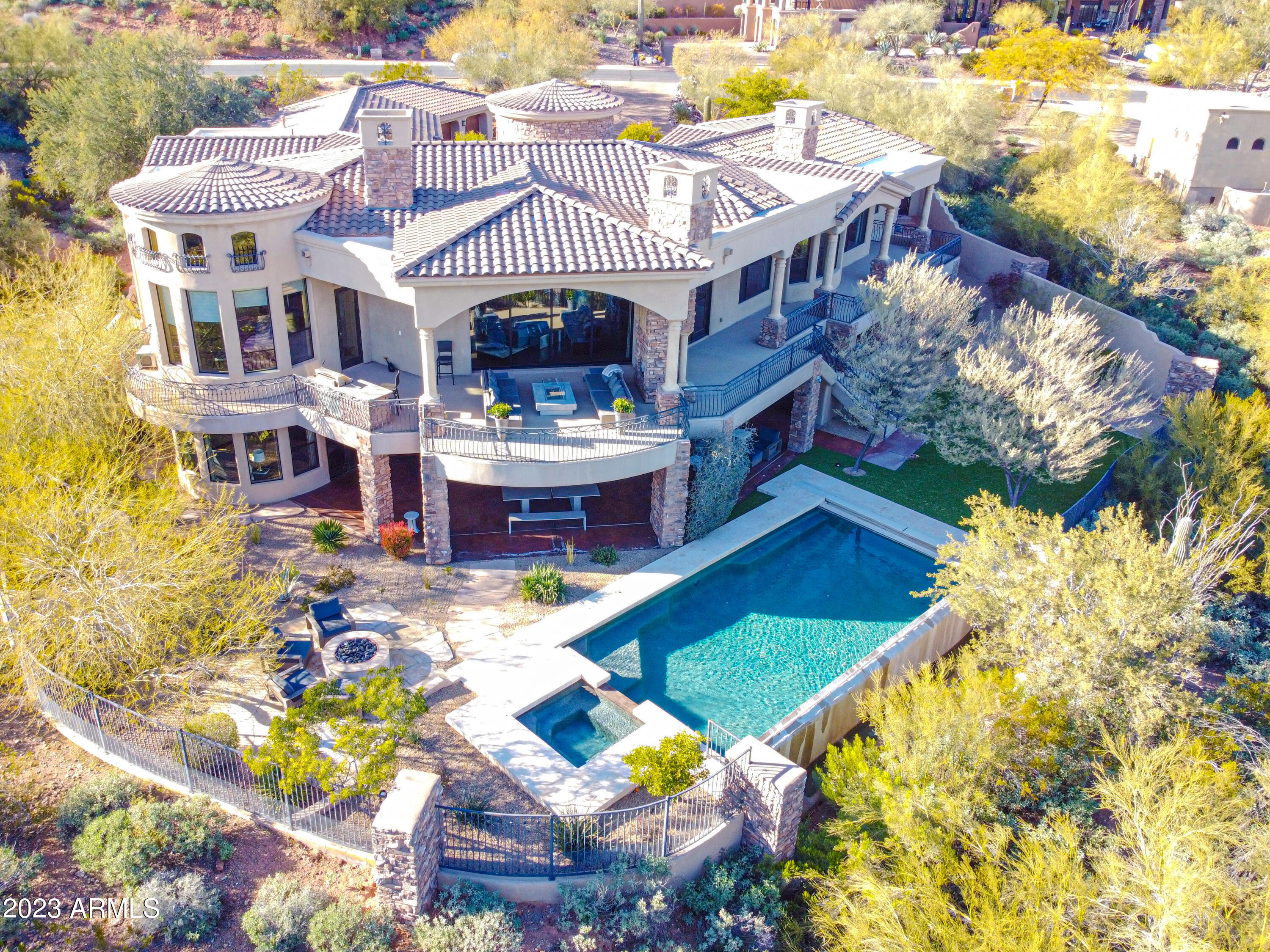 Luxurious hillside estate perfectly situated in the guard-gated Firerock Country Club. This home was featured in Phoenix Home & Garden Magazine. Absolutely one of the best-view properties in the city overlooking the magnificent Red Mountain & Firerock Country Club's 14th green. This Tuscan estate offers elegance around every corner with master-crafted stonework, majestic archways, spectacular high ceilings, and an elegant living room with wall width disappearing doors that opens up to the wrap-around veranda. An impressive Chef's kitchen with Wolf appliances, gorgeous thick edged granite counter tops & breakfast bar, 2 refrigerator drawers & a warming drawer, a large-scale island & stunning crown molding cabinetry. This lavish master suite features a plethora of natural light, a fireplace to provide a relaxing ambiance, an impressive bathroom & direct access to the wrap around balcony. The large lower level offers a game room/shuffleboard & wet bar, a home theatre, as well as direct access to your tranquil oasis. This home is a testament to the beauty of Fountain Hills. 
Furniture is available on a separate bill of sale.