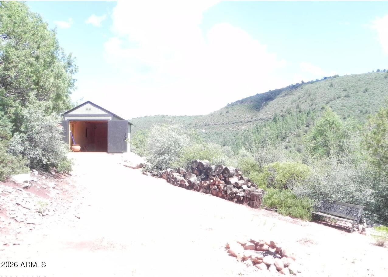 Looking for your own private basecamp in the pines? This Geronimo Estates getaway delivers that true outdoors-lover vibe. Set on General Use land, it's the perfect spot to roll in with the toys, unplug, and soak up wide-open forest views. Two 10' × 20' hunter cabins sit tucked among the trees and can be powered by a generator--ideal for gear storage, a cozy crash spot, or a rugged weekend retreat. One cabin has been used to house a Razor and doubles as living space when you're up in the high country. Spend your days exploring the woods, then settle in by the fire as the sky lights up with sunrise and fades into sunset. Your own slice of forest freedom is waiting.
