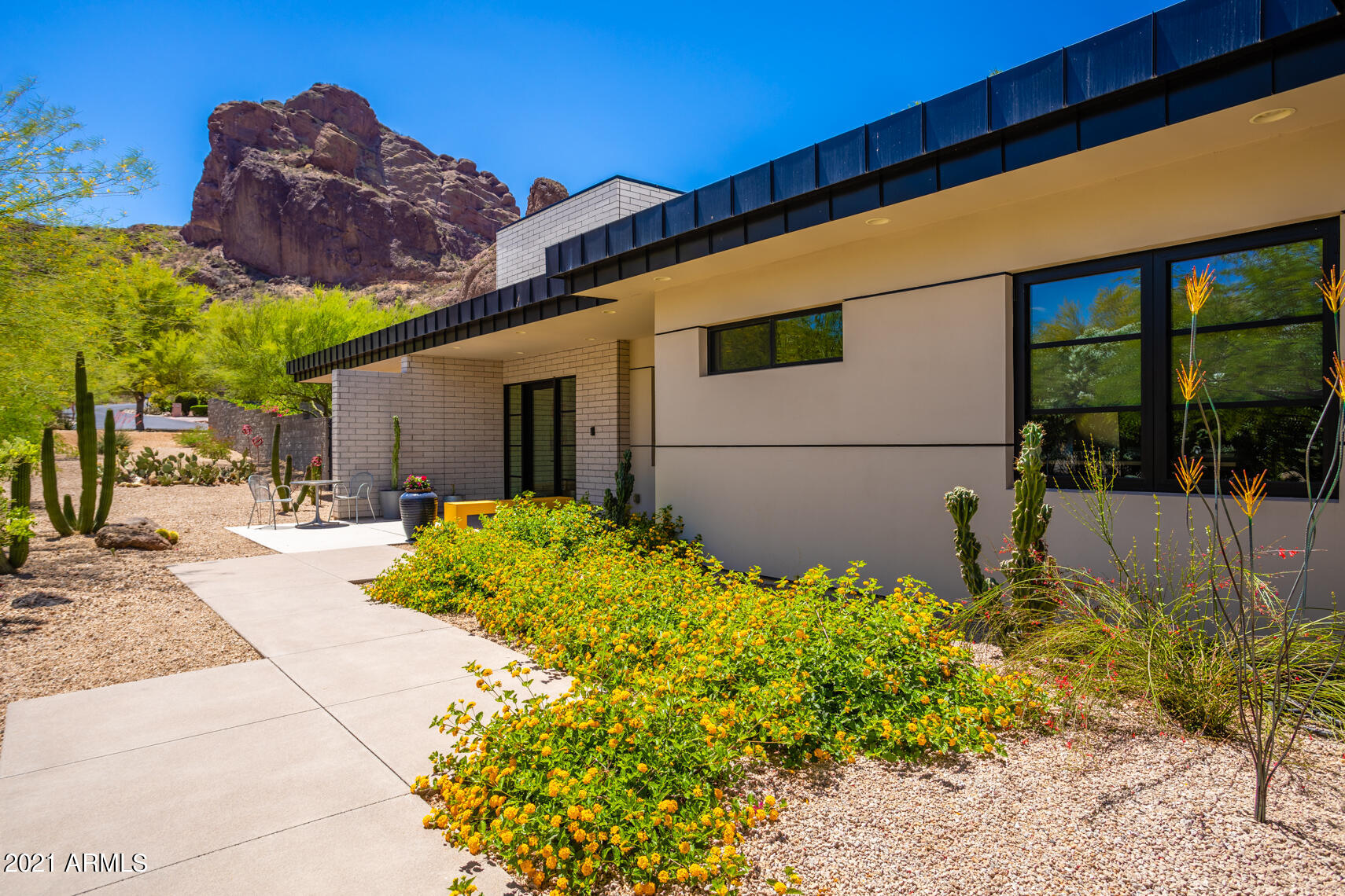 Dream View! This Modern contemporary home in the heart of Paradise Valley located in this most desirable neighborhood has the in-demand features for today! Inside: honed concrete floors throughout, all on one level. Walnut veneer millwork, 24' stacking slider for indoor/outdoor living. Top-line appliances, open great room concept. Large kitchen island, leather finished stone top plus quartz counters. Bedrooms all w/en-suite baths. Large Owners suite makes this ''perfect sized''. Outside: white honed block, crisp steel detail steel, timeless desert design. Views will astound you! Large pool, manicured synth-lawn w/putting green, mature palms. Solar array for great rate! 3-car garage w/frosted glass doors. Come for the view, stay for the quality!