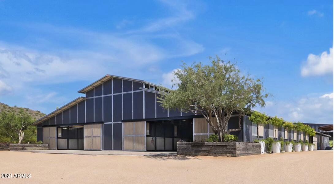 Welcome to the Ruckman ranch. An exquisite equestrian facility nestled in the heart of North Scottsdale. At just under 19 acres, Ruckman Ranch is a horseman's dream. Boasting over 67 stalls, this state of the art facility has 3 barns, 4 living spaces, a 70x70 shop, 125x250 covered arena, and a 150x300 outdoor track. You'll also find a covered eurociser, 2 large round pens; one also covered, and 5 RV hookups. The covered arena not only has plenty of room, it boasts 3 Big Ass Fans, 16 Bluetooth speaker and LED lighting to keep those utility bills in check. Additionally, automated sun and wind screens that will deploy with a push of a button. The opulent viewing lounge has a full kitchen, bath, custom wine wall and gorgeous designer finishes throughout. Over looking the covered arena, the 16' tall, 6 panel glass pocket door opens all of the way up so you can bring the inside out for parties, events or just to enjoy the great Arizona winters while watching your favorite horses. The main residence is 4350 sqft 4bd/3.5bath and 3 car garage. Newly renovated in 2018, the entire second floor contains the master suite with an office, a wet bar; and views for days. The fenced in backyard is very private with views and has a pool and kiva fire place.