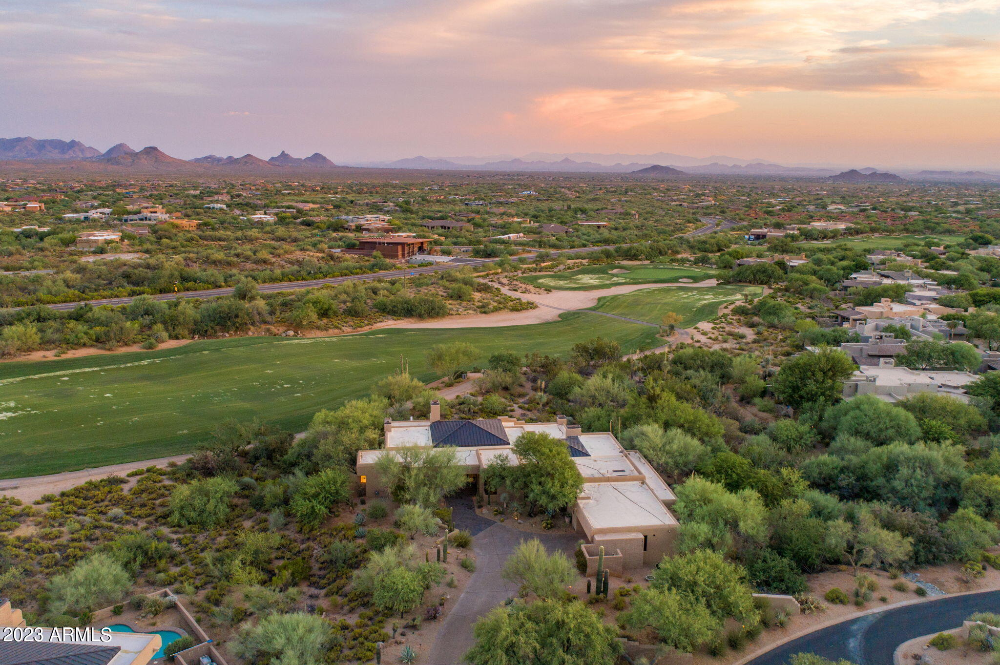 Turnkey and golf membership available-Bespoke remodel with farmhouse and contemporary elements curated with city lights, Pinnacle Peak and surrounding ranges that rise before you. Seated at Apache's 4th fairway and green, the primary suite offers elevated spa views in total privacy from your covered patio. Primary bath suite with soaking tub, steam shower and dual vanities in mocha and alabaster. Farmhouse style kitchen has generous island in wood and granite, cabinets and backsplash detailed in a palette of dark dove grey & pale cloud. Guest en-suites split for the comfort of all in residence within an intelligent floor plan designed for spacious entertaining. Billiard room and gaming tables open to patios with southwest views. Botanical gardens delight with exotic cacti, flora and fauna