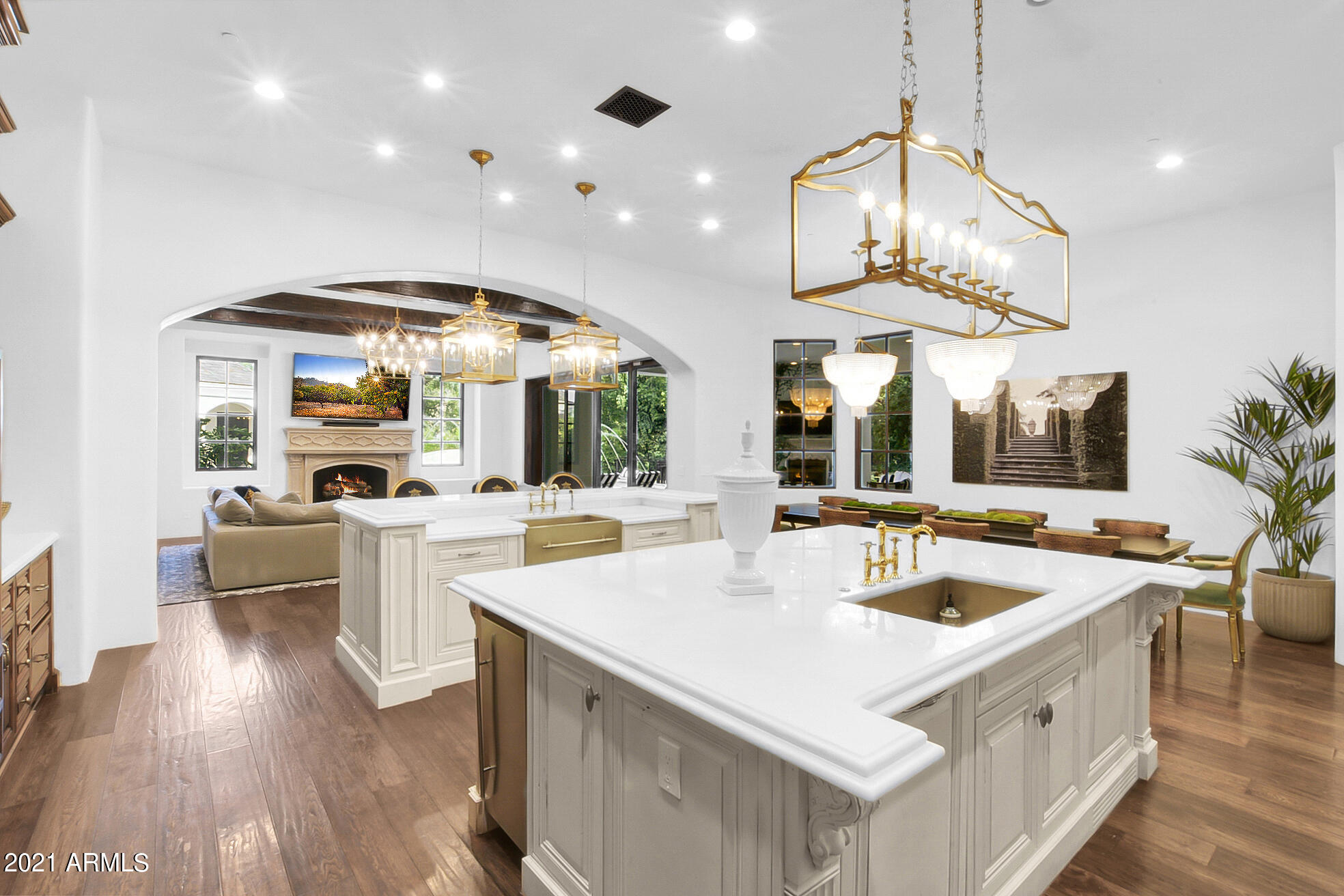 Sale includes 7,644 sf HOME on 30,064 sf lot PLUS  33,396 sf ADJOINING LOT WITH IT'S OWN parcel number 314-04-497. TWO PARCELS BEING SOLD AT THIS PRICE PLUS, all within the Southeast Valley's most sought after and sold out gated community. This estate has undergone an extensive modernization and top to bottom remodel! New custom lighting is exquisite! Custom chef's kitchen, custom hand made cabinetry and commercial grade appliances. Soaring ceilings, sweeping staircases, grand foyer & enormous roll open doors bring the inside living to the outdoors. EVERY BEDROOM has on suite bath, private washer & dryer & walk in closet!  Your family will LOVE the game room! Backyard feels like a private resort w/enormous outdoor living room w/fireplace and misters. You don't feel like you're in AZ when.. you walk into this backyard! Mature trees, beautiful vegetation and vines, tree swings, hammocks and no neighbor in your back yard.  WOW! This ESTATE property is impressive! You're getting two lots so you can choose to build on second lot should you choose, but let me make it clear, there are two separate parcel numbers being sold. One includes the existing home and the other currently is being used as part of the existing backyard, but could absolutely be built on. Call Jody for more details and come see this one today, before it's gone!