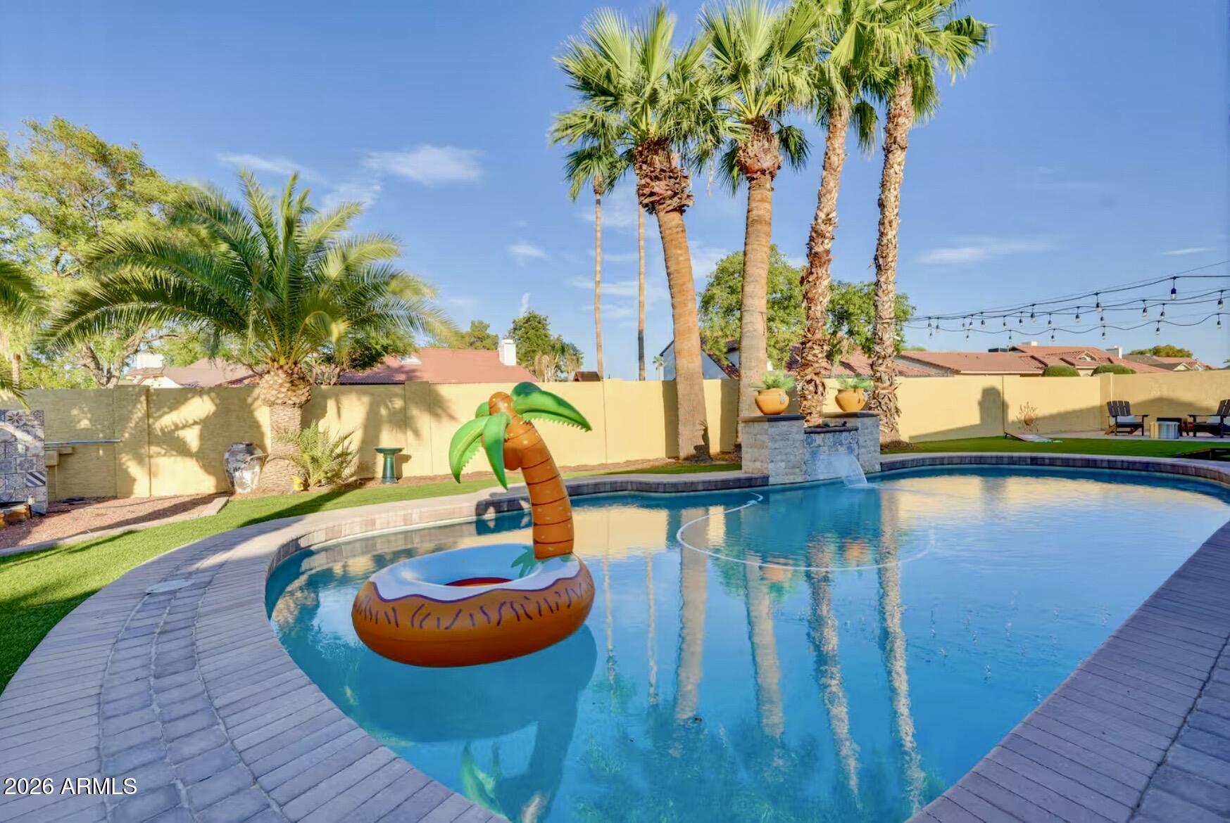 Discover a fully enclosed Villa with 2-car gar. PLUS workshop & no HOA--an exceptional find. This timeless home has been elevated with thoughtful renovations, creating a warm, resort-like retreat. Tile flooring keeps the interior cool, while expansive picture windows & skylights bathe each room in natural light. The kitchen features an elegant eat-in island ideal for morning gatherings or buffet-style entertaining. The newly updated walk-in primary spa shower adds a touch of luxury. Surrounded by palm trees & birdsong, this haven sits just 15 minutes from PHX airport & premier shopping. Stroll down Ellis to a large park. Love Hallmark holidays? ''Christmas on Upland Drive'' brings the magic home each season.