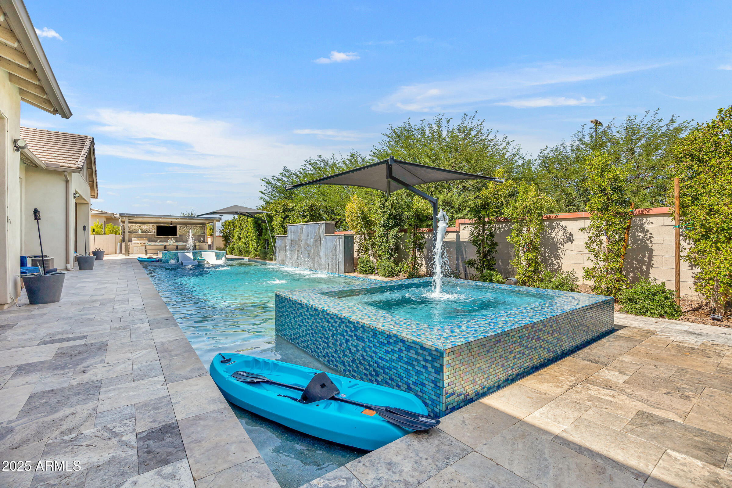 Priced below appraisal for immediate interest and sale, this property stands out as one of the most compelling values in the luxury segment of the Southeast Valley. this residence offers expansive living spaces, and resort-style amenities designed for both elevated everyday living and impressive entertaining. Recently repositioned to align with current market conditions, this exceptional luxury estate presents a rare opportunity in one of Gilbert's most desirable enclaves. Stunning resort-style residence in the guard-gated community of Whitewing at Germann that offers the ultimate in luxury living and entertainment, while also being perfectly suited for multi-generational living. Nestled in the heart of Gilbert, this one-of-a-kind property **Key Features:**

**Entertainer's Paradise:** The expansive 140 feet of built-in backyard entertainment space is unmatched, featuring 2 luxurious spas, a sparkling pool, and multiple seating areas perfect for intimate conversations or large gatherings. The outdoor kitchen is a chef's dream, offering ample space for large barbecues and unforgettable al fresco dining under the Arizona skies.

**Owner's Suite:** 1,200 sq. ft. of private living with custom **dual** walk-in closets, a separate spacious TV/exercise room, and 16-ft. bathroom ceilings.

**Second Primary Suite:** En-suite bedroom with a spacious layout and 700 additional sq. ft. added, including a private sitting area and walk-in closet, separate from the primary bedroom wing.

**Casita:** Beautifully remodeled into a baker's dream, featuring a gourmet kitchen, abundant cabinetry, soaring 10-foot ceilings, and 700 square feet of fully livable space, complete with washer and dryer hookups, making it ideal for separate living quarters.

**Impressive Game Room:** With 12 TVs, this game room is like no other, complete with ceiling-mounted televisions, a video arcade room, gaming tables, and a 16-foot bar with ample seating perfect for entertaining or watching sports with friends.

**Private Wine Room:** Wine enthusiasts will love the custom wine room, a sophisticated space designed to showcase and store your collection.

**Home Theater:** Movie lovers will be in awe of the professionally designed Dolby Atmos home theater, offering an immersive cinematic experience for family movie nights or private screenings. Sixth bedroom is currently utilized as the home theater.

**Multi-Generational Living:** Thoughtfully designed to accommodate multi-generational families, this home offers ample space and privacy for everyone. Whether you're hosting extended family or accommodating live-in caregivers, this home provides the flexibility and comfort you need.

**Expansive Side Yard & 4-Car Garage / Pool House Plans:** The property includes fully permitted and approved plans for additional garage space and a pool house ideal for storing recreational vehicles and entertaining. The expansive side yard offers endless possibilities for customization.

*Climate-controlled, insulated garage with a separate 5-ton AC unit great for supercars or keeping vehicles cool through the summer. Also includes audio/video setup and epoxy floors, making it suitable for entertaining.

**Prime Location in Gilbert:** Only 2 miles from the 202 freeway and SanTan Village shopping area. Located minutes from the 272-acre Gilbert Regional Park, close to beautiful lakes for recreation, extensive hiking trails, and just 3 hours from Mexico and 2.5 hours from Arizona's mountain retreats. This home offers the perfect balance of serenity and accessibility.

This exceptional property is a rare find offering the best of indoor and outdoor living, a wealth of entertainment options, and multi-generational flexibility, all in a highly sought-after Gilbert location. **Don't miss this opportunity to own your dream home!