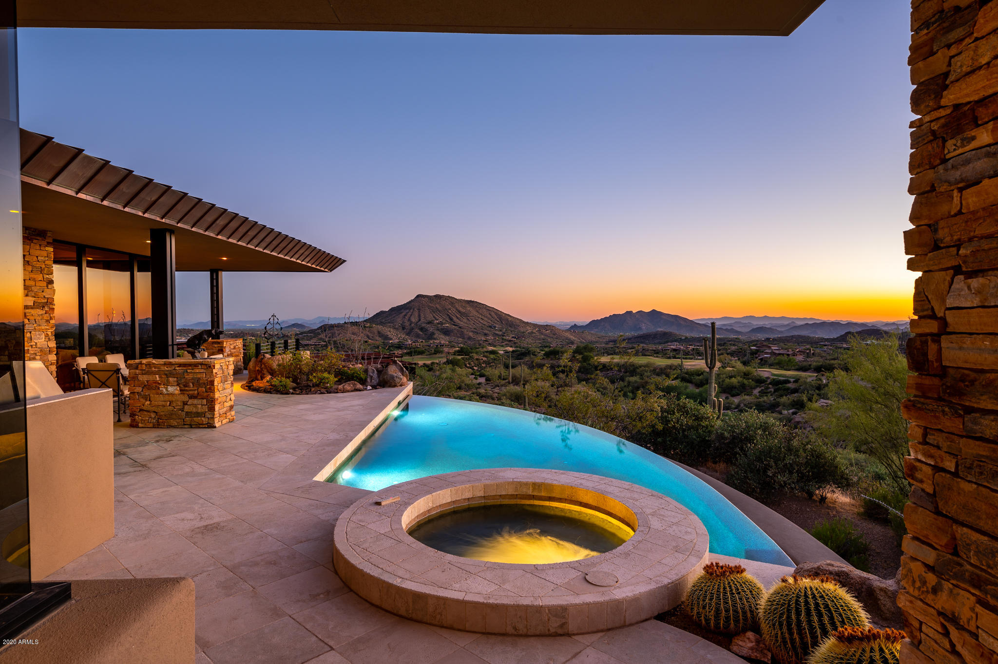 Contemporary Southwest Jewel Box situated in Prestigious Village of Cochise Geronimo. Breathtaking Views of Golf courses, mountain, city lights and sunsets all year round. Just bring your toothbrush,  as this home is priced fully furnished, including art and a membership to the Desert Mountain Club. Tastefully decorated and impeccably maintained. Shows like a model home.  Designed by Bing Hu. Main home features an elegant master, office with a full bath, great room with bar, a junior master and cook's kitchen, all overlooking several fairways of the Geronimo Golf Course. Downstairs is a theater, guest room and sitting area with private patio. The guest house has a bedroom with a private patio and a sitting area. The home also has a 4 car garage.