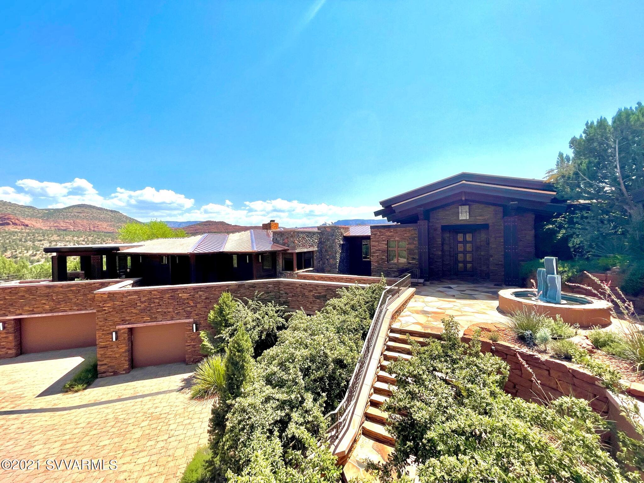 This special home on a private 2.23 acre lot is beautifully built by Randy Toogood and designed by Stephen Thompson.  The home backs to green space along Dry Creek and the State Park. All the finishes are of the highest grade and taste. The outside of the home is wood and river rock for a grand look. The new roof is made of copper.  The home hosts not only the main home but a separate guest casita.  The home itself has a floorpan that allows for privacy for owner and guests.
The kitchen has everything a gourmet chef could ask for and there are two more kitchen/bars in the lower level and guest house.  The Formal Dinning Room is gracious and so is the Great Room.  They overlook a panoramic view of the mountains. The private theater seats 10 comfortably. This is truly a magnificent home.