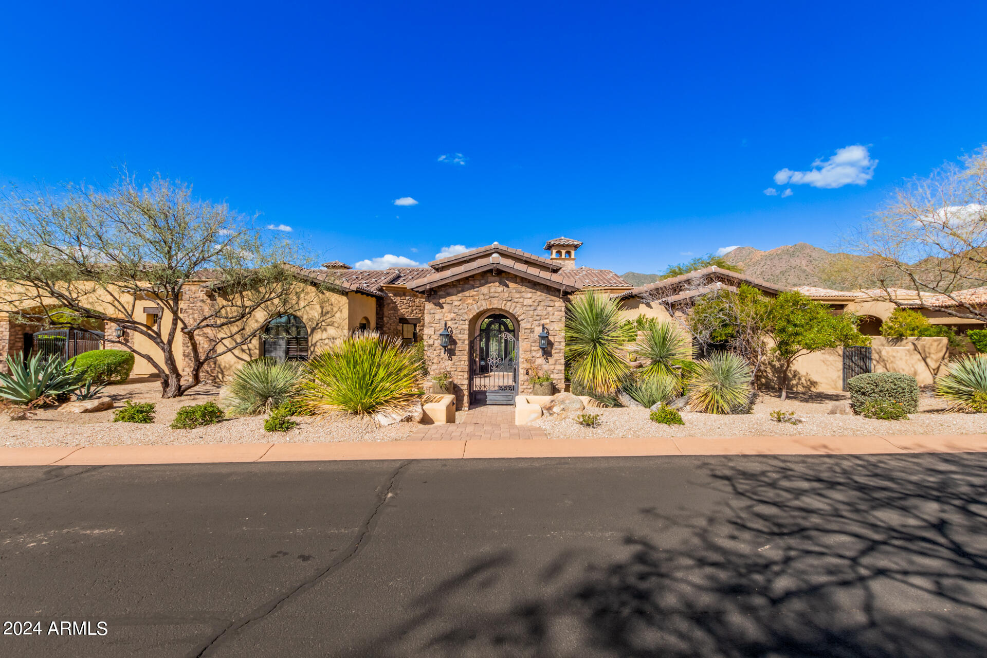 This exquisite home in Sierra Hills is a sight to behold. Its stunning facade is made of Cantera stone and is complemented by a professionally-landscaped front yard and a private courtyard with a fireplace and fountain. The interior of the house is just as impressive with its beautiful archways, intricate light fixtures, stone pillars, and exposed beams. The open floor plan includes a formal dining room, a wet bar, a wine rack, and a living/dining area that features a wood-burning fireplace and glass sliding doors that lead to the backyard. The great room is equally impressive with its wide windows that provide ample natural light and a cozy fireplace. The 4-car garage, Travertine tile floors, and pre-wired surround sound system add to the luxurious feel of the home.