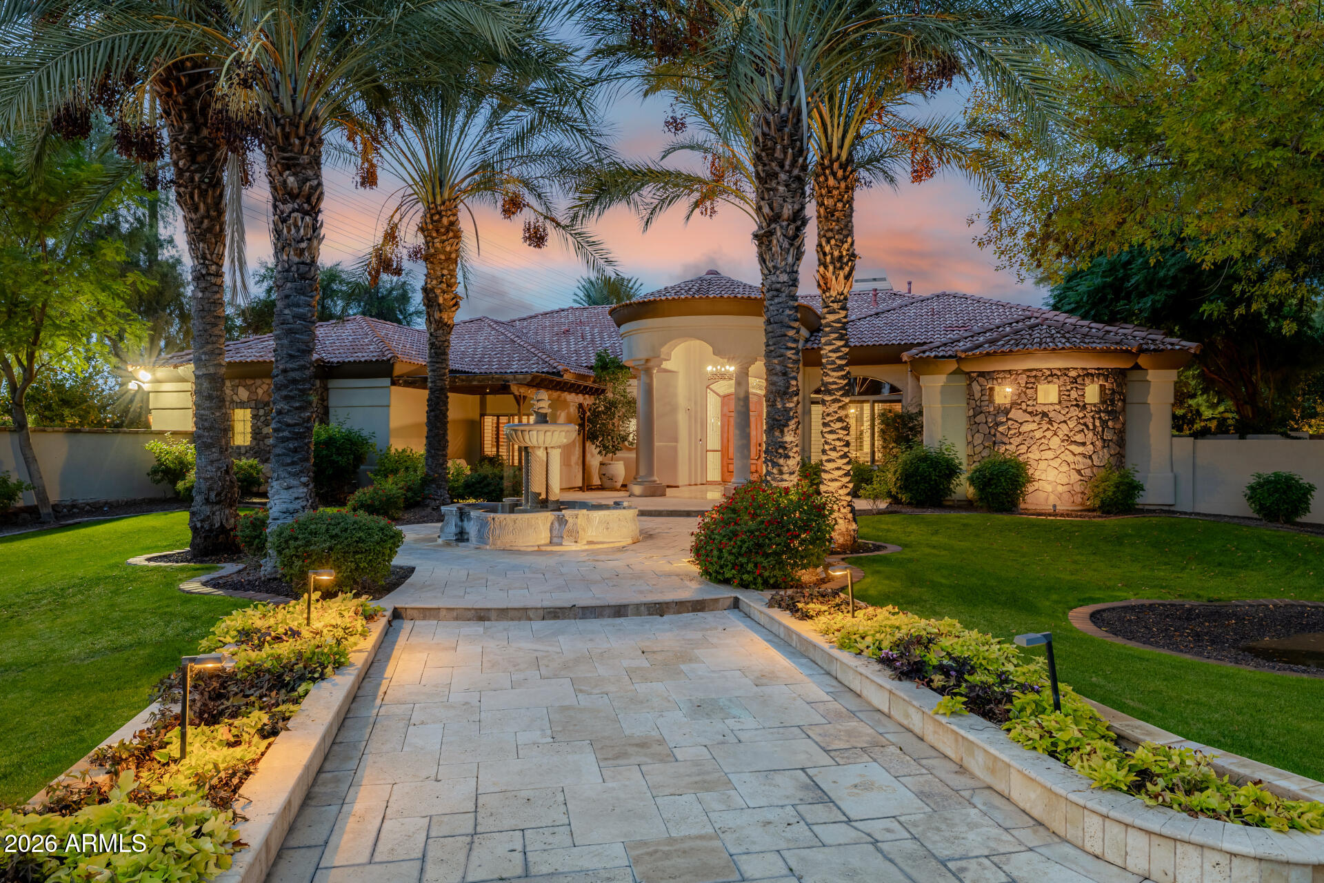 Welcome to one of the most extraordinary custom estates in Gilbert, Arizona. This highly upgraded Forte built residence offers resort-style living, unparalleled entertaining spaces, and a breathtaking backyard oasis built by Red Rock Pools and featured on HGTV and The Travel Channel. At the heart of this 1.2 acre gated property is a gorgeous 140,000-gallon swimming pool, featuring a 12-foot waterslide, grotto, elevated 15-person spa, kid pool, and separate adult and teen swim areas - creating a true private vacation retreat. The backyard also boasts two outdoor kitchens, an outdoor dining room with gas fireplace and two distinct outdoor living rooms. Putting greens sit adjacent to a private skate park near the rear of the lot, completing this one-of-a-kind outdoor experience. Guests will enjoy complete privacy in the 2400 sq. ft. detached guest house, which includes two bedrooms with two full bathrooms, a full wall of sliding glass doors with a view of the waterfall, a full kitchen, dining and living spaces, laundry room, and covered patio.

The main residence features a desirable split floor plan, anchored by a luxurious primary suite with fireplace, wood flooring and exquisite bathroom. Formal living spaces showcase a large bar area with backlit onyx wall, alabaster light fixtures, and granite countertops. The custom chef's kitchen is equipped with a Viking gas range and top-of-the-line appliances. Secondary bedrooms include one en-suite bedroom and two bedrooms with Jack-and-Jill bathroom, all with generous walk-in closets.
A three-car garage plus a two-car garage that has been converted into a private distillery and cigar bar, adding yet another unforgettable element to this showpiece estate.
Truly a once-in-a-lifetime residence designed to impress, built to entertain, and impossible to replicate.