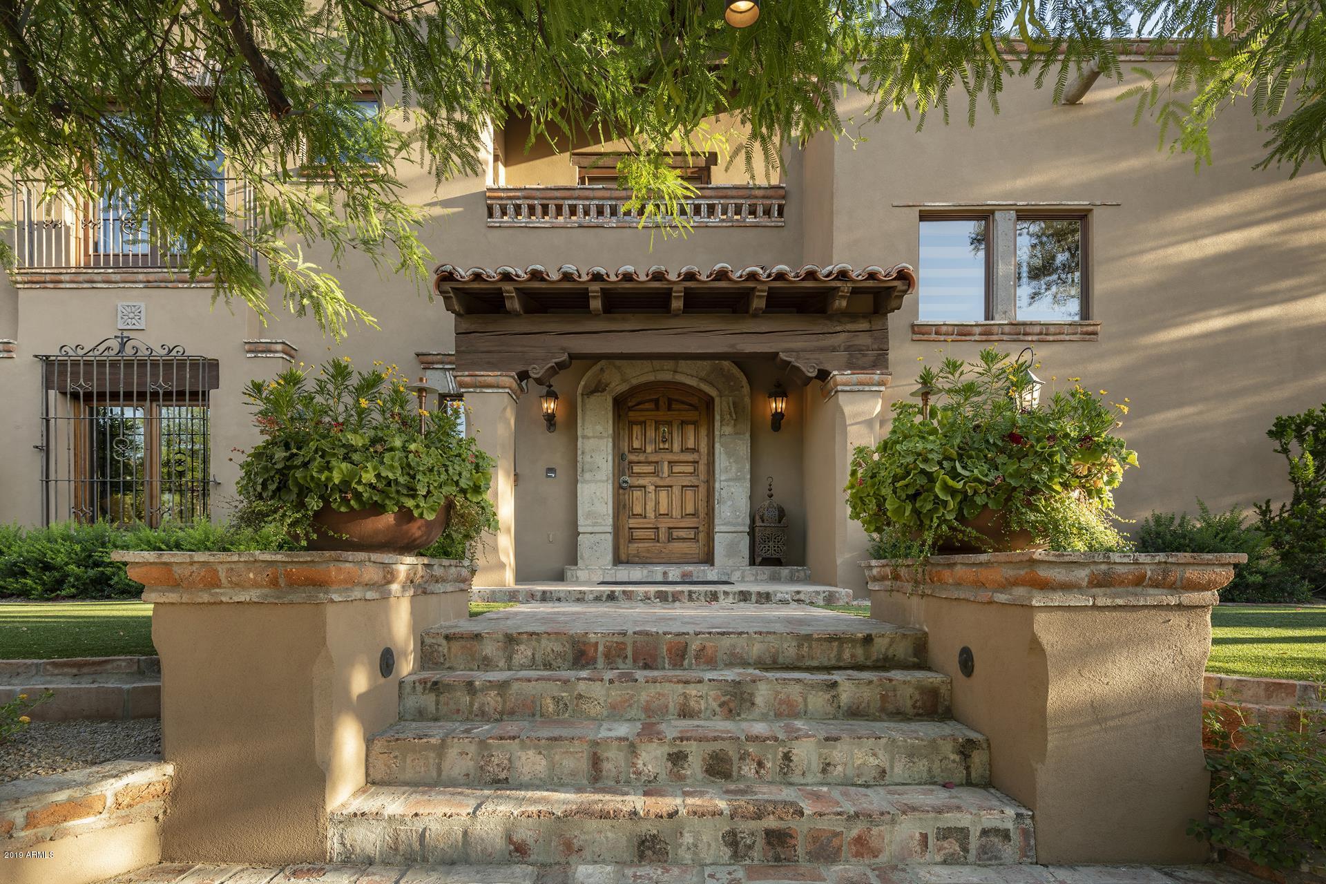 WELCOME TO PV HOLLYWOOD HILLS! This intimate and charming Jewel Box home is perched on a mountain with abundant outdoor spaces taking full advantage of expansive valley views. Entertain like never before in the sumptuous kitchen, extensive covered patios, private Ramada overlooking the pool & spa, PGA quality putting green and chipping area, sport court, and fully integrated Bang & Olufsen audio system. Enjoy the highest quality craftsmanship with pure, genuine, & masterful finishes, from the vintage ironwork imported from Mexican haciendas to the grand stone fireplaces all painstakingly & passionately fashioned by hand. Single level living with only a study, guest bedroom, & loft above. ALWAYS IN VOGUE a Spanish Colonial Masterpiece - unlike any other in Paradise Valley.