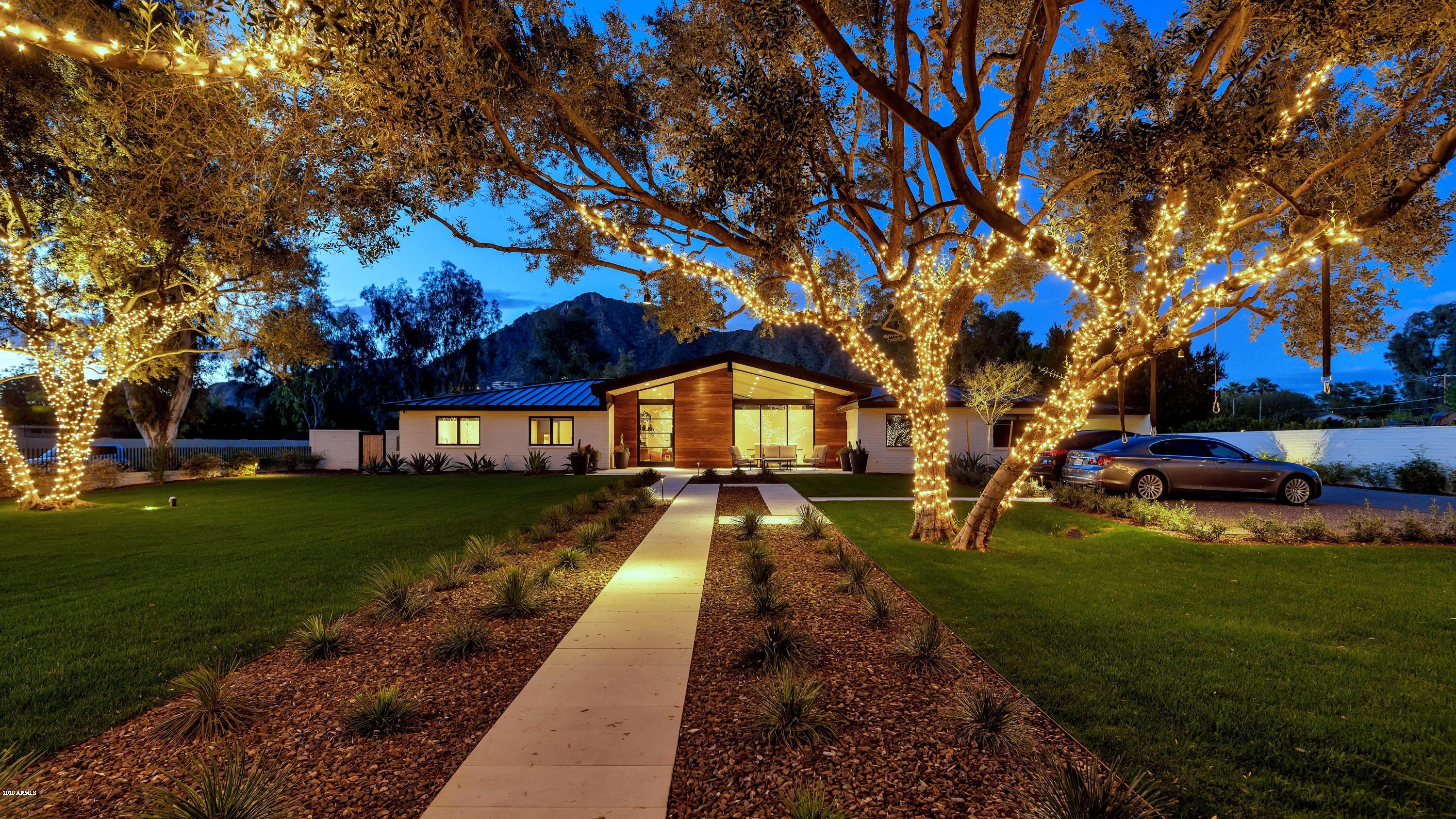 This exceptional home is built with pure quality and outstanding taste! The contemporary architecture is absolutely breathtaking, and the innovative finishes are beyond impressive. The home flows beautiful with clean lines and open spaces creating a perfect combination of grandeur and charm.  This kitchen is extraordinary, as is the great room, the dining room is elegant, yet comfortable, the office could persuade anyone to work from home, the playroom is every child's dream and a phenomenal guest house is in the works. All of the bedrooms and bathrooms are ultra-cool, including a chic master hideaway that has a very unique and very stylish master bath. Fully retractable doors lead to over the top outdoor entertaining spaces, a huge yard and the most magnificent mountain views! This modern showpiece sits on a fabulous lot on the most coveted street in Arcadia. And to top it off it's a total smart home loaded with incredible technology. Who could ask for more?