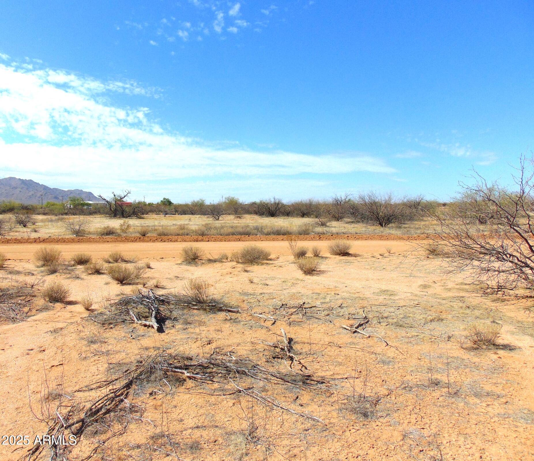 COUNTRY LIVING AT IT'S BEST!!  Beautiful 5 Acre Parcel with water and power to the front of the property. Ready for a Custom Home or Manufactured home on this level acreage with no washes that maximize potential building and land use.   Excellent sandy, loamy soil for riding, gardening, whatever you enjoy. Beautiful mountain views in every direction in this fast-growing area that is experiencing lots of new growth.   You have all paved roads within one block from the property with a well-maintained gravel road to property. Situated in fast growing Pinal County halfway between Phoenix and Tucson, just outside of Casa Grande with easy access to I-10. Several new industries are coming into the surrounding area.