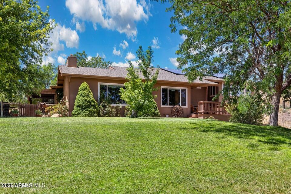 Chino Valley Horse Property is perfectly situated on 3.03 Acres. Updated 2109 Sq. Ft. Home. Lovely open living area includes gorgeous wood flooring, stacked stone gas fireplace & mountain views from the new picture windows. Kitchen is renewed with granite counter tops, updated alder cabinets and appliances; including the beautiful retro style gas range. The Arizona room is heated & cooled, a versatile space that can be used for a guest room, hobby room, exercise or crafts. Spacious primary bedroom suite with soaking tub & walk in shower. Comfortable guest bedroom. A covered deck off the Arizona room leads to the paver patio & walkway to the horse set up. Fenced and cross fenced , with a hay /equipment shelter and 2 run in stalls. RV parking is possible with electric hook up. Laundry room has storage, utility sink & very convenient 3/4 bathroom. Under house storage. Great well, pump replaced 5/2023 with 3 years warranty remaining. NO HOA! SOLAR, low APS bills.