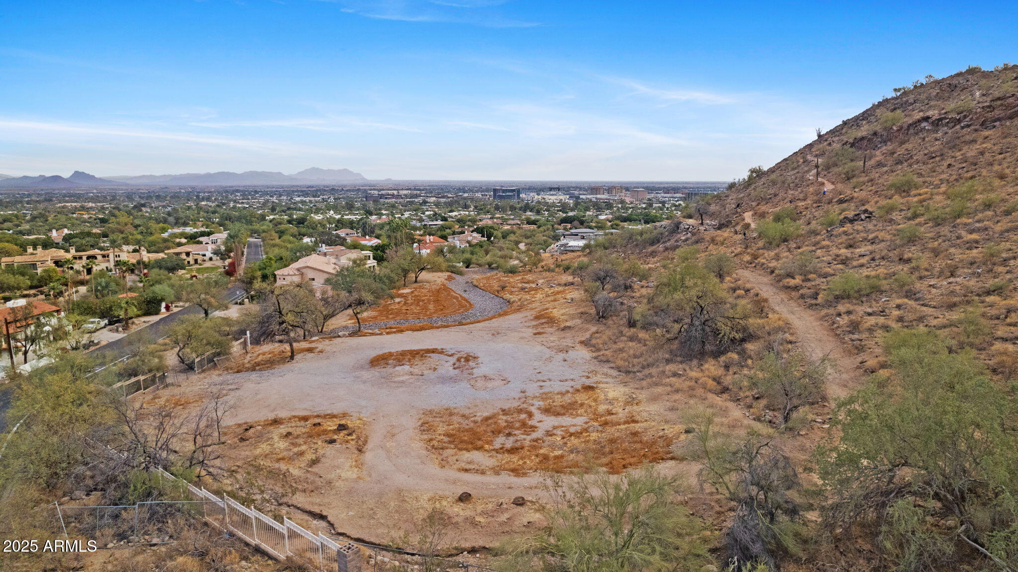 Discover the pinnacle of luxury living with this 1.8-acre view lot, ideally located on the prestigious north side of Camelback Mountain. This rare offering provides breathtaking, unobstructed views of the McDowell Mountains, Pinnacle Peak, shimmering city lights, and beyond.

The lot comes with an approved grading plan for a spacious 36,000-square-foot building pad, ensuring a seamless path to crafting your dream estate. Enhance your vision with conceptual plans for a 10,000 sf residence done by the renowned Stratton Architects.

Whether you're drawn by the allure of iconic desert landscapes or the promise of privacy and luxury, this property is an unparalleled opportunity to create a legacy home.