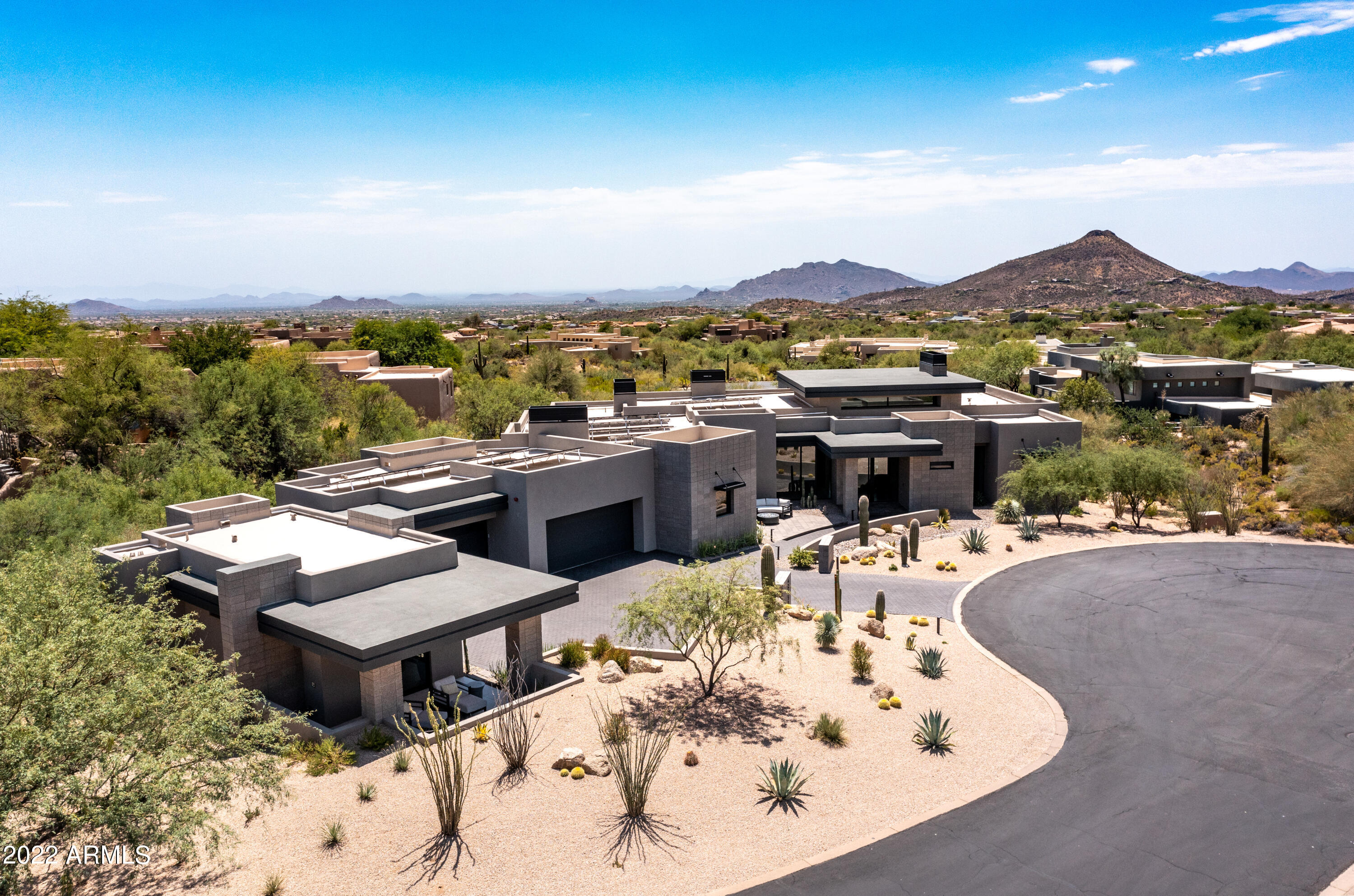 Distinctive, contemporary home in Desert Mountain completed in 2020 by Blackstone Homes with interiors done by Ownby Design. This home captures today's buyers needs perfectly! Ideal floor plan with master bedroom and office/media room on one side of home and two ensuite guest bedrooms on other all on one level. Additional ensuite casita allows for added privacy or longer-term guests. The heart of the home is the oversized greatroom/chefs kitchen with top of the line Wolf and Subzero appliances, large hidden pantry, Taj Mahal quartzite counters on 16 foot island, and custom walnut cabinetry. The kitchen, great room, and master all have telescoping door systems that seamlessly blend the inside with outdoor spaces for everyday casual living and larger entertaining needs. The resort like