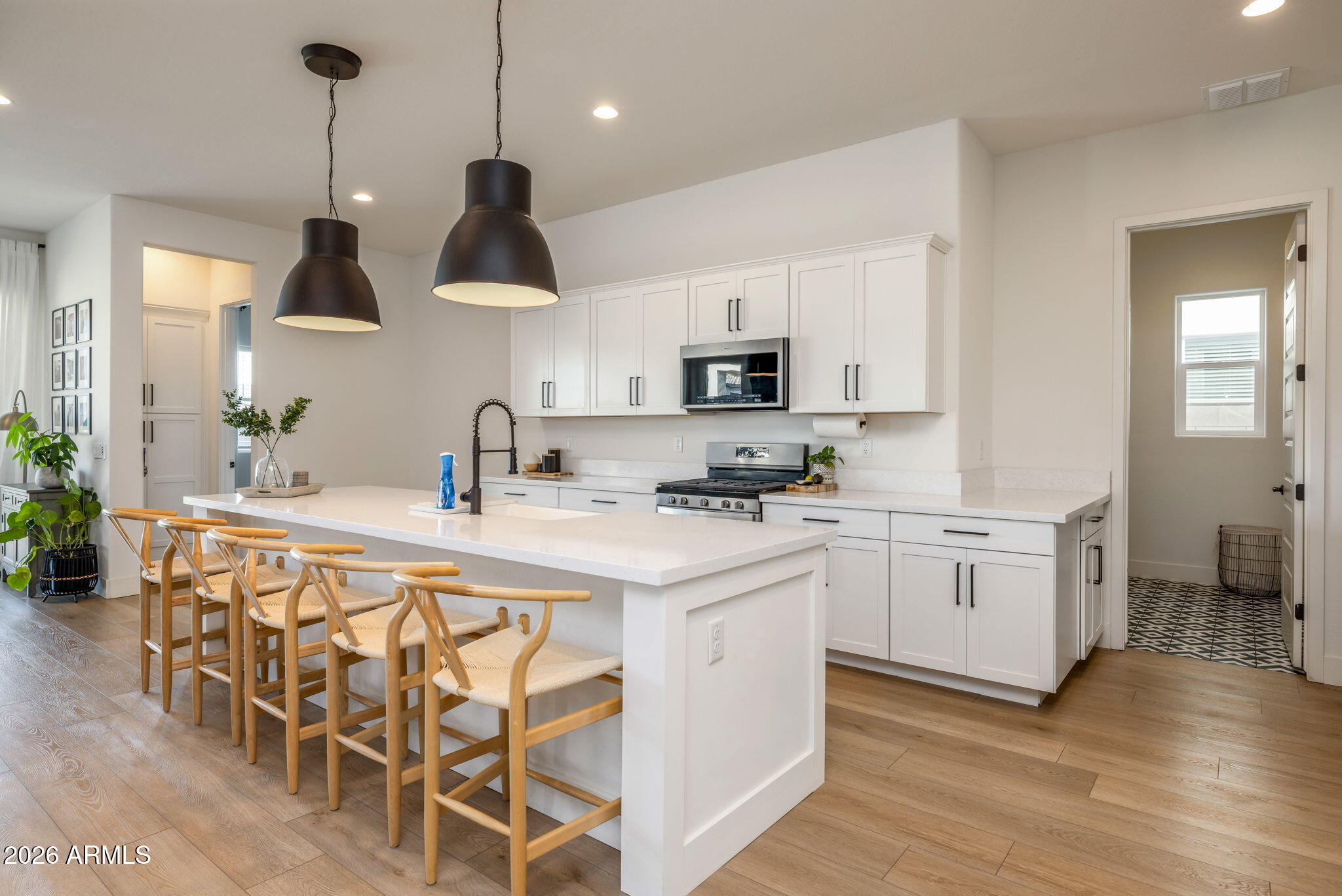 Experience luxury single-level living in one of Southeast Mesa's most desirable master-planned communities. Built by Toll Brothers in 2021, this beautifully designed 3-bedroom, 2-bath home offers nearly 2,000 square feet of thoughtfully crafted living space with the quality, architecture, and attention to detail that has made Toll Brothers one of America's premier luxury homebuilders. From higher-end finishes and elevated design standards to spacious layouts and exceptional craftsmanship, this home stands apart from typical production builders.

Perfectly positioned with no rear neighbors, the home backs to a peaceful greenbelt, creating added privacy and scenic views rarely found in newer communities. Inside you'll find an open-concept great room filled with natural light, upgraded flooring throughout, generous living spaces, and a seamless indoor/outdoor flow ideal for entertaining or everyday living. The low-maintenance backyard lets you spend more time enjoying your home and less time maintaining it.

Living in Cadence at Gateway means enjoying resort-style amenities including a community pool, spa, fitness center, parks, playgrounds, sports courts, walking trails, and year-round neighborhood events. Beyond the community, you'll love being just minutes from Eastmark, one of Arizona's premier master-planned communities, offering popular restaurants, coffee shops, retail, entertainment, and community gathering spaces. The surrounding Gateway area continues to see significant investment with additional neighborhood retail planned within Cadence, continued residential development, and major employment growth centered around Phoenix-Mesa Gateway Airport and the expanding Gateway East business district, bringing new shopping, dining, hospitality, and high-tech employers to the area. 

With convenient access to Loop 202, SR-24, Phoenix-Mesa Gateway Airport, and top-rated schools, this home offers the perfect combination of luxury, convenience, and long-term value in one of the Valley's fastest-growing corridors.
