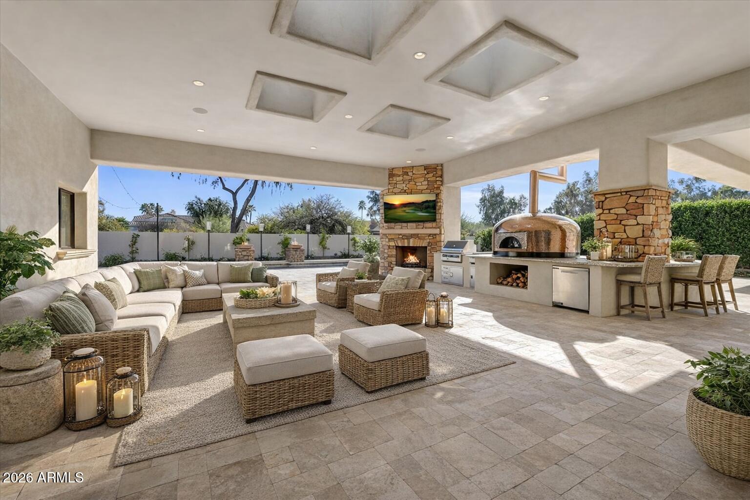 Privately positioned within the gated enclave of Rancho Santa Fe, this fully reimagined estate offers refined luxury on a premium .7-acre lot. One of only fourteen homes in the community, the residence sits quietly at the back of the neighborhood, delivering exceptional privacy and presence.
A gated courtyard with fresh landscaping and limestone detailing creates a striking arrival. The home has been comprehensively refurbished, blending timeless architecture with modern sophistication. Grand formal living and dining spaces are accented by exquisite limestone detail and large-format Italian porcelain tile, opening seamlessly to the resort-style backyard. The heart of the home is the expansive great room, featuring a chef's kitchen with Michelangelo marble and Taj Mahal quartzite countertops, a new 60-inch Wolf range, Zephyr hood, and premium finishes throughout. The residence is thoughtfully designed across three private wings, offering ideal flow and privacy, including a luxurious primary suite, private office or wine tasting room, guest suite, three additional en-suite bedrooms, and a secondary family room.
Designed for elevated indoor-outdoor living, the backyard features a grand covered patio with commercial-style pizza oven and built-in BBQ, a tiled diving pool and spa with all-new equipment and heater, artificial turf, extensive new pavers, integrated sound system, and a private sport court.
Extensive upgrades include a new roof, all-new HVAC systems with multiple garage AC units, tankless water heaters, new plumbing fixtures, updated bathrooms, new flooring throughout, limestone enhancements, Savant lighting system, security cameras, fully hard-wired networking, updated interior and exterior speakers, and MyQ smart garage door openers. The four-car garage is fully finished with epoxy flooring and climate control.
A rare opportunity to own a turn-key estate that lives like new construction within one of Scottsdale's most coveted gated communities.