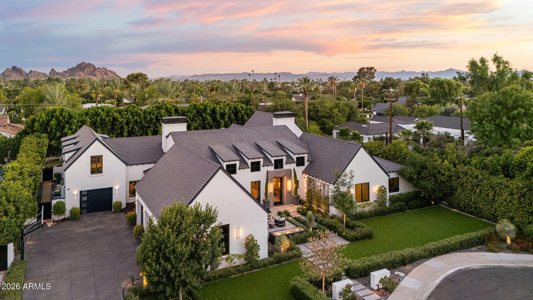 Some homes are built. This one was envisioned. A private world. A front-row seat to Camelback Mountain. An address that defines Arcadia. Privately positioned at the end of a coveted cul-de-sac on nearly one acre, this extraordinary 2019 custom estate by Brett Brimley offers nearly 7,000 SF, 5 ensuite bedrooms, 5.5 baths, a private guest suite with kitchenette and garage, executive office, media lounge, and seamless indoor-outdoor living. Resort-style amenities include a negative-edge pool, elevated spa, Twin Eagles outdoor kitchen, sports bar, Control4 smart home, Sub-Zero & Wolf appliances, climate-controlled golf simulator-ready garage, and breathtaking mountain views--just minutes from Scottsdale, Paradise Valley, world-class dining, luxury shopping, golf, and Sky Harbor.