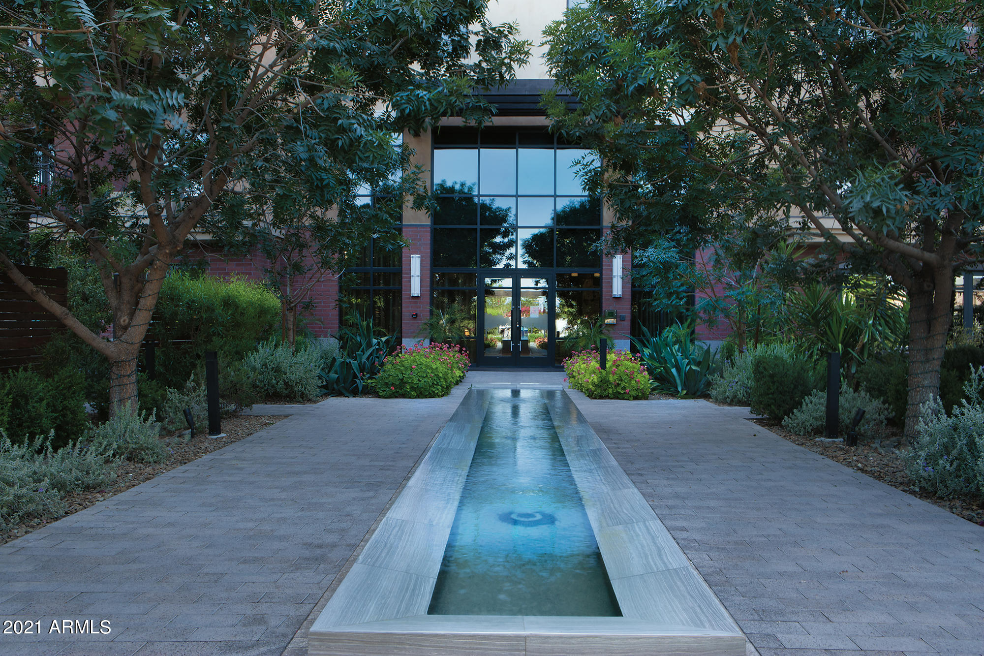 This private residence is located in the center  of the most desirable neighborhood. The Enclave at Borgata offers resort style living with amenities to match and is quickly redefining luxury living. Gated entry, 24/7 concierge, intimate gardens, pool, spa, club room and large fitness center are just a few to name. This timeless corner penthouse is ideally located in the community to capture Camelback mountain and expansive city views. The soft Portuguese limestone floor invites you in as you are greeted by the elegant millwork, Calcutta marble and Wolf appliances. This unit includes double masters, formal dining, large living area, library, great room and also has gracious outdoor living spaces. This condominium home is the perfect lock and leave that is positioned walking distance to shopping, restaurants and entertainment. Located below the home is a private 4 car garage in addition to two assigned parking spaces.