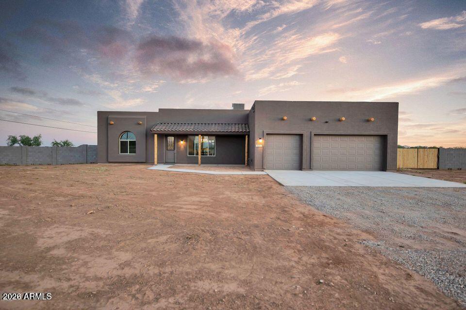 New Home on 1-acre lot with a fully enclosed block wall, RV GATE & NO HOA. 4 bed 2 bath 3-car garage! Spacious split floorplan, 10' ceilings  8' doors, upgraded lighting, and a 12' sliding glass door to the patio. Additional upgrades include a large quartz center island, Soft-close cabinets, under-cabinet lighting, stainless steel appliances and hood, a tiled backsplash, and a walk-in pantry.  The primary bedroom and bathroom include a glass walk-in shower w/ beautiful tile, 2 walk-in closets, double sinks, a private toilet room, and an exit to the outdoor patio. Enjoy this new home in the country with a short drive to town. This home should be completed the beginning of June.