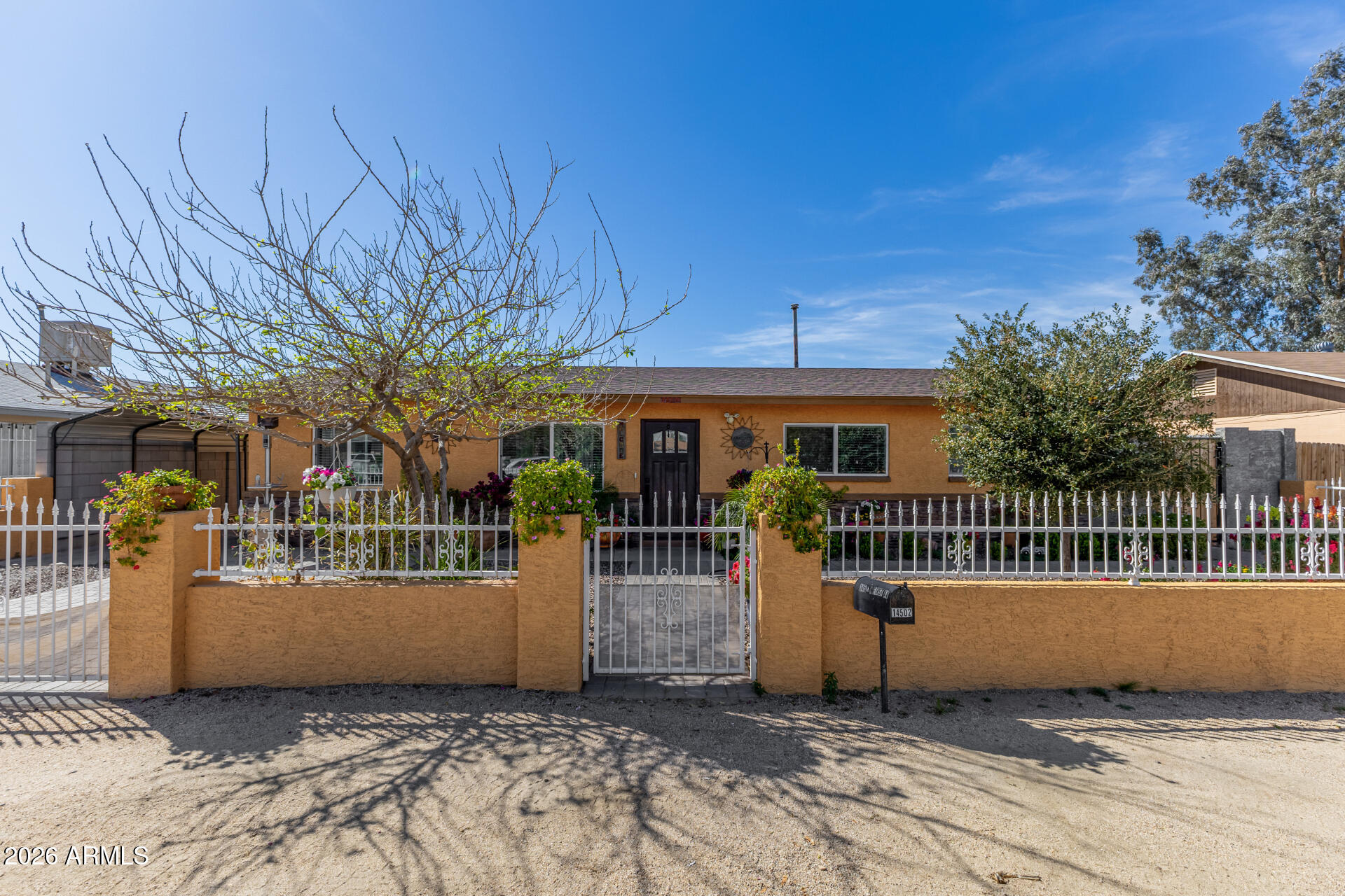 Adorable single-story home with no HOA! Beautifully manicured and gated front patio. Inside, you'll find an inviting living room with wood-look flooring, plenty of natural light and neutral paint throughout. The well-appointed kitchen features white shaker cabinets, tile backsplash, quartz countertops, and built-in appliances for a seamless cooking experience.  The backyard features an extended covered patio, perfect for morning coffee and weekend grills, as well as ample seating space, a grassy area, and RV gates. This home is a must-see!