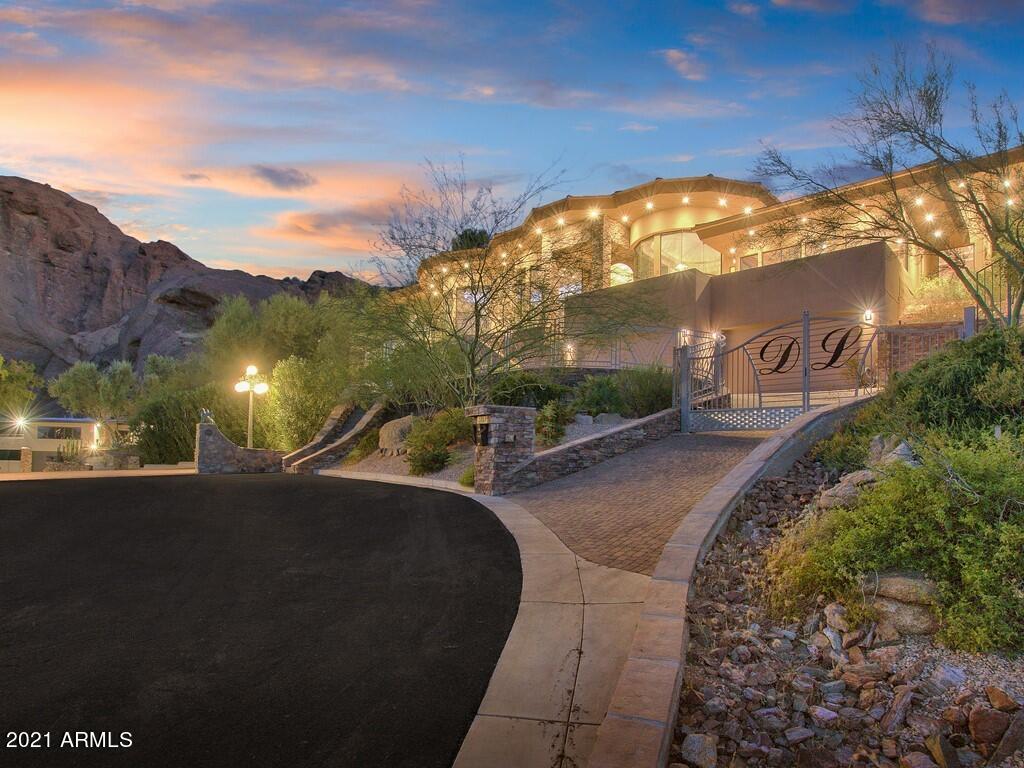 PRIVATELY GATED HILLTOP ESTATE! THIS EXTRAORDINARY HOME BOASTS 7050 SQUARE FEET PROVIDING EXPANSIVE VIEWS OF ECHO CANYON, SQUAW PEAK, MUMMY MOUNTAIN AND TWINKLING CITY LIGHTS. A CAMELBACK MOUNTAIN CUL-DE-SAC LOT. NOTHING SHORT OF SPECTACULAR. DRAMATIC, LARGE GLASS WALL AS YOU ENTER THE GATE. THIS 4 BEDROOM AND 5.5 BATHROOM HOME INCLUDES A 6-CAR GARAGE, NEGATIVE EDGE POOL AND RELAXING SPA, THEATRE OR GAME ROOM WITH A WET BAR, 800 BOTTLE WINE CELLAR, EXERCISE ROOM AND GOURMET KITCHEN. TAKE A STEP THROUGH THE FRONT DOOR TO AN ELEGANT FOYER AND SPACIOUSLY LAID OUT FLOOR PLAN. ON THE MAIN LEVEL ENJOY A GRAND FORMAL LIVING AREA AND SEPARATE FORMAL DINING ROOM WITH EXQUISITE STYLE. 20 FOOT CEILINGS IN BOTH THE LIVING ROOM AND FAMILY ROOM AREAS. SPACIOUS CHEF'S KITCHEN AREA WITH EAT-UP BAR SEATING, CENTER ISLAND WITH PREP SINK AND GAS COOKTOP, DUAL WALL OVENS, MATCHING OVERLAYS, LOTS OF STORAGE SPACE AND WALK-IN PANTRY. EATING NOOK JUST OFF THE KITCHEN AREA WITH INCREDIBLE VIEWS. GREAT ROOM AREA WITH FIREPLACE AND GLASS WALLS TO THE EXTERIOR THAT PROVIDES IMMACULATE VIEWS IN THE BACKDROP. THE MULTI-LEVEL EXPANSIVE OUTDOOR LIVING SPACE ENCOMPASSES A LAVISH POOL, SPA AND DINING AREA. ELEVATOR FOR EASY ACCESS TO THE GARAGE LEVEL. YOU WILL LOVE THIS EXTENDED LUXURIOUS MASTER SUITE WITH IT'S VIEWS! LARGE SEATING AREA AND ACCESS TO PRIVATE VIEWING DECK, YOU'LL NEVER WANT TO LEAVE. MASTER BATH INCLUDES DUAL SINK VANITIES, SOAKING TUB, WATERFALL SHOWERHEAD AND LARGE WALK-IN CLOSET. ALL ADDITIONAL BEDROOMS HAVE FULL EN-SUITE BATHS. CONVENIENTLY LOCATED NEAR UPSCALE SHOPPING, RESORTS, SPAS, VARIETY OF ENTERTAINMENT AND FINE DINING. BETWEEN PARADISE VALLEY AND THE BILTMORE. THE LIST GOES ON AND ON!
