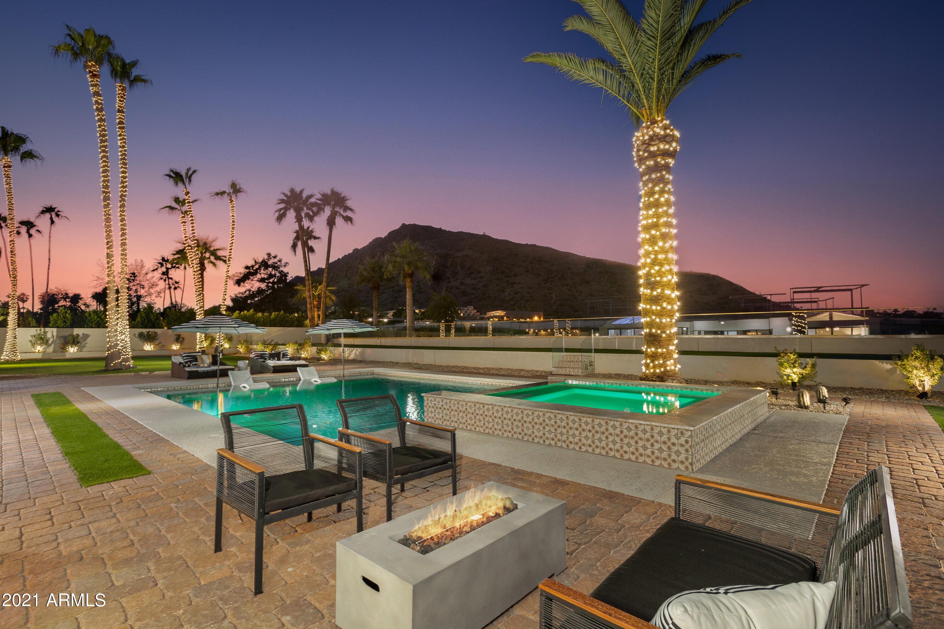 A PROPERTY BEYOND COMPARE!!     SITUATED AT THE BASE OF ICONIC 'CAMELBACK MOUNTAIN' ON THE 'PHOENICIAN GOLF COURSE',   HEAR THE RECOGNIZABLE  'PING'  OF BALL & CLUB IN THE DISTANCE!    SCOTTSDALE'S PREMIER LUXURY BRAND 'MwM VICSDALE'  HAS DESIGNED AN ESTATE THAT COMBINES THE FEEL OF THE WORLD'S FINEST EXCLUSIVE RESORTS WITH THE MOST PEACEFUL LIVING SCOTTSDALE HAS TO OFFER!!     THIS SENSATIONALLY DIFFERENT  'MwM'  HOME IS TRULY AN OWNERS PERSONAL, TRANQUIL PARADISE!!........
The home has incredible street appeal where 'MwM' designed & built in symmetry with numerous gardens, courtyards & fluid open plan design.  Enter the imposing foyer, welcoming you into 4 double volume reception areas with exposed beams, hardwood floors, wood paneling detail throughout & focal point 6 foot 'Heat & Glo' marble covered gas fireplace with entertainment areas tumbling out onto the huge terrace with built in BBQ & outdoor kitchen.  Windowscapes and large stacking sliders capture the exuberance of manicured rolling lawns of turf, flanked with 2 putting greens, towering palm trees, heated pool with baja tanning deck & jacuzzi to soak in the spectacular views.  The picture book state-of-the-art Signature 'MwM' kitchen is at the heart of the home has 2 parallel 16 foot banquet islands & is fully integrated with Subzero/ Wolf appliances with a cocktail bar for evening pleasure! 

The home offers 4 large en-suite bedrooms, each one, unique in style & design with spa like bathrooms tucked behind 'hand -made' Barn Doors with free standing tubs, walk in rain showers, private courtyards. outdoor view showers, dual vanities, & Closets, gentleman's study, relaxing TV pajama lounge, all adorned with Restoration Hardware Chandeliers & handpicked Fans.  The big driveway will park your guests, 3 car garaging with Electric car charging station & inside laundry with washer/dryer ensures you have all the amenities you desire WHILE YOU ARE TRANSPORTED TO AN ESCAPIST FANTASY WORLD!  ONLY A SELECT FEW WILL HAVE THE PRIVILEGE OF OWNING & LIVING IN THIS MAJESTIC SETTING!