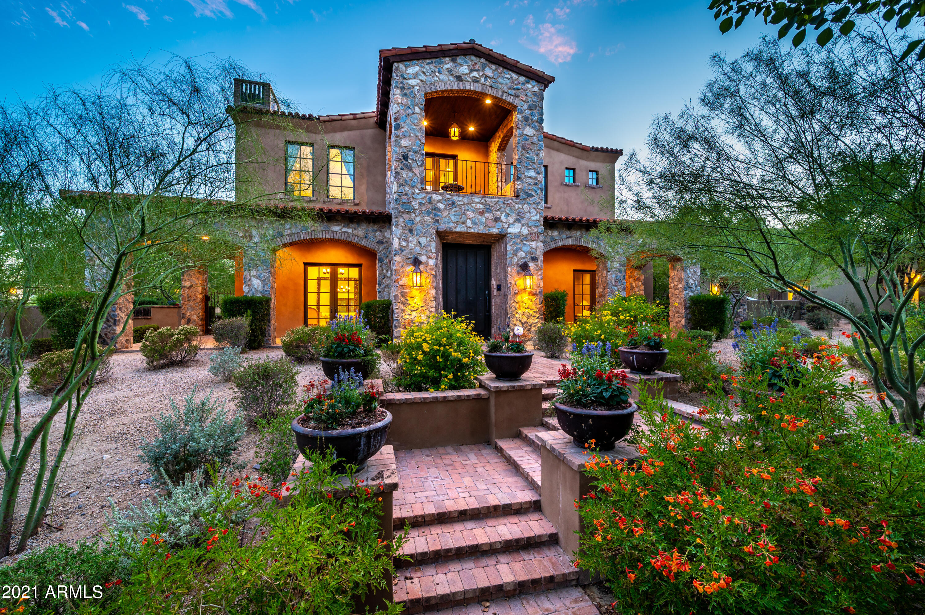 Beautiful estate in Arcadia at Silverleaf surrounded by lush greenery, majestic treelined streets and mountain views. This custom home sits across from Arcadia's largest park on a corner Signature Lot, indicating the highest standard of architecture and landscaping as required during its build process. Fresh yet timeless design, this home showcases bright, neutral colors, implemented with lasting style and taste. The desirable floor plan features a gourmet kitchen with walk-in pantry, open great room with 14-foot ceilings, en-suite bedrooms, bonus office space with plenty of storage, and oversized laundry/craft room. With the highest quality throughout, this home boasts meticulous stonework, solid wood floors and doors, reclaimed wood beams, masonry fireplaces, hand-painted artisan tiles and handcrafted ironwork. Entertain and enjoy Arizona living with your own outdoor oasis, featuring two ample enclosed yard spaces, Pebbletec pool and spa, large stone firepit, and multiple patios and balconies that showcase views of the mountains, park and pool. Bonus features include Control 4 Smart Home and upgraded 4-car garage, finished with the same quality as the home. Located in one of Arizona's most premiere communities, this home is a must-see for those seeking a luxurious, relaxed lifestyle near all that North Scottsdale has to offer!