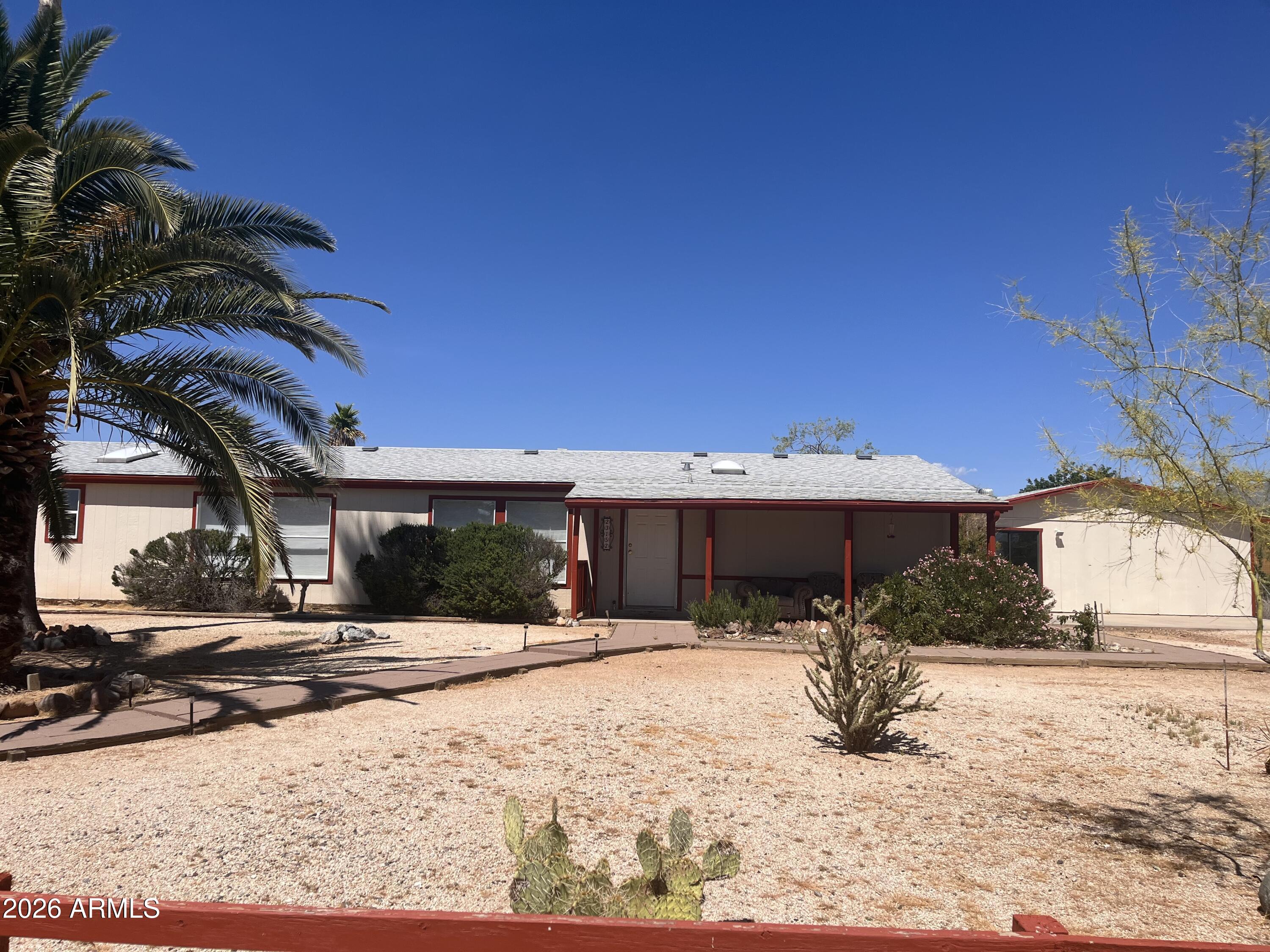 Some homes are just a place to live. This one is a place to breathe. Set on .8 private acres and cradled by towering mature cacti, this 4-bed, 2-bath desert retreat invites you to slow down and settle in. The renovated European kitchen -- outfitted with pull-out drawers and warm butcher block countertops -- is as functional as it is beautiful. Vaulted ceilings lift the space, while the master suite's soaking tub and step-in shower offer a quiet refuge at the end of the day. Step onto the patio and let the mountain views do the rest. New flooring, blinds, and paint mean the heavy lifting is done. A detached studio, 2 sheds, ATV gate, carport, and a water feature ready to sing again complete this one-of-a-kind property. Top-rated Congress Elementary nearby. Sold as-is.