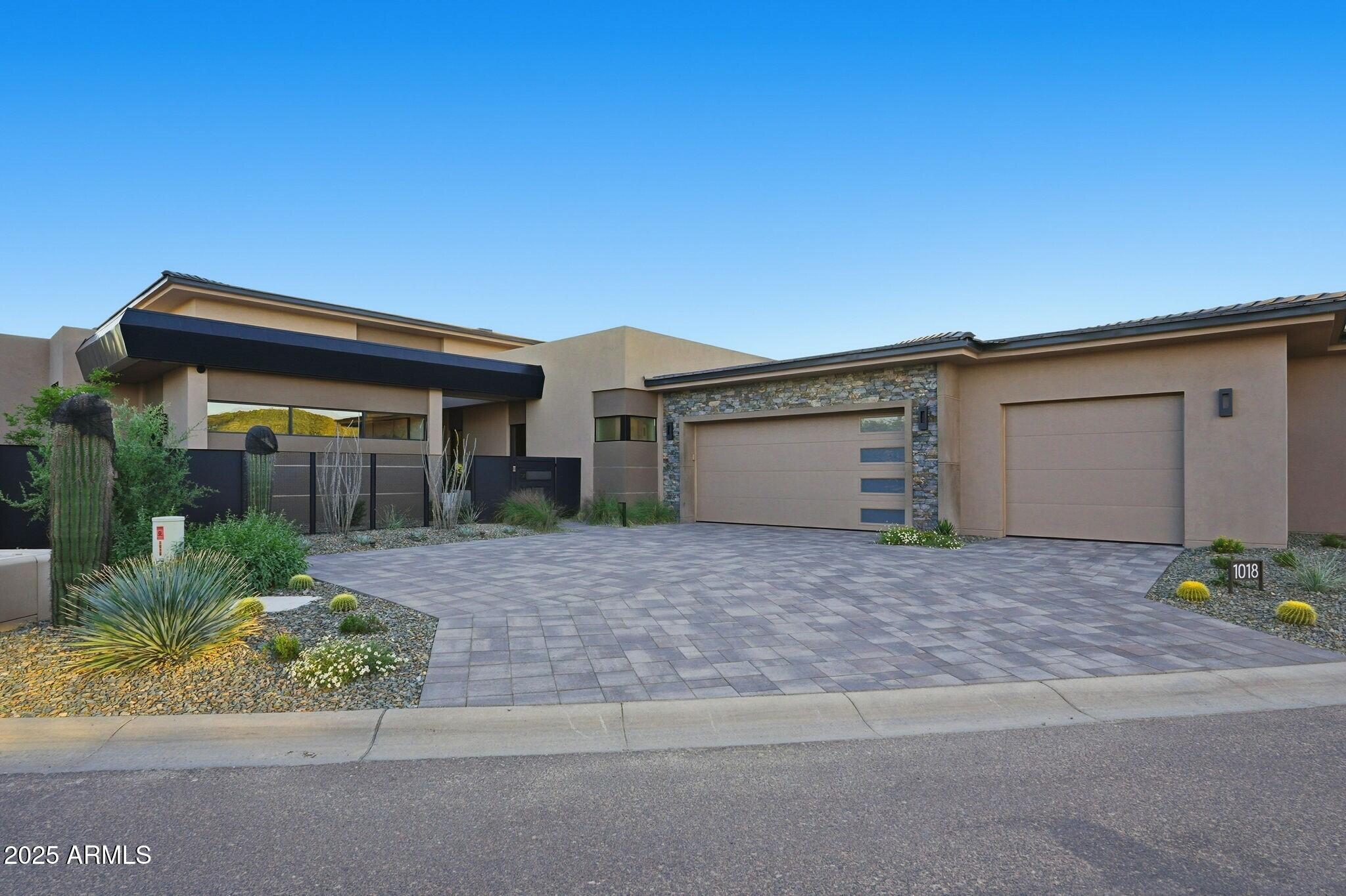 Experience the Essence of the Sophisticated Cowboy! This home includes the opportunity for an immediate Full Desert Mountain Golf Membership -- no waiting necessary.
Step through the private courtyard and be welcomed by a striking 10-foot full-glass door leading into a grand double-height foyer. This turnkey, fully furnished, and automated new build by Cullum Homes blends warmth and elegance through sophisticated colors, rich materials, and refined textures.
The thoughtfully designed split floor plan ensures privacy for the primary suite, featuring a private walkout to the pool and breathtaking mountain and golf course views. Each guest room offers its own ensuite bath and custom walk-in closet, creating a perfect blend of comfort and luxury. In the great room, a stunning floor-to-ceiling fireplace becomes the centerpiece, surrounded by walls of glass that flood the space with natural light and accentuate the soaring double-height ceilings. The open-concept layout flows seamlessly into the kitchen and dining area, enhanced by designer ceiling details, warm tones, and elegant finishes.

The office, with its rich molding and immersive color palette, provides a serene and inspiring environment. Even the laundry room impresses with its stylish and functional design.

Step outside to the back courtyard and enjoy entertaining or simply taking in the views. The sparkling pool, complete with fountain and fire features, offers the perfect setting to soak in the spectacular golf course and mountain scenery.

This incredible home embodies the true spirit of refined desert living, a must-see masterpiece of style, comfort, and sophistication. Set within the exclusive Village at Seven Desert Mountain, residents enjoy access to world-class amenities, including the newly renovated Sonoran Spa and Fitness Center, premier tennis complex, scenic hiking and biking trails, six private championship golf courses, and an array of luxurious clubhouses and restaurants. The community is guard-gated 24/7, ensuring the utmost in security and convenience for the highly sought-after lock-and-leave lifestyle.