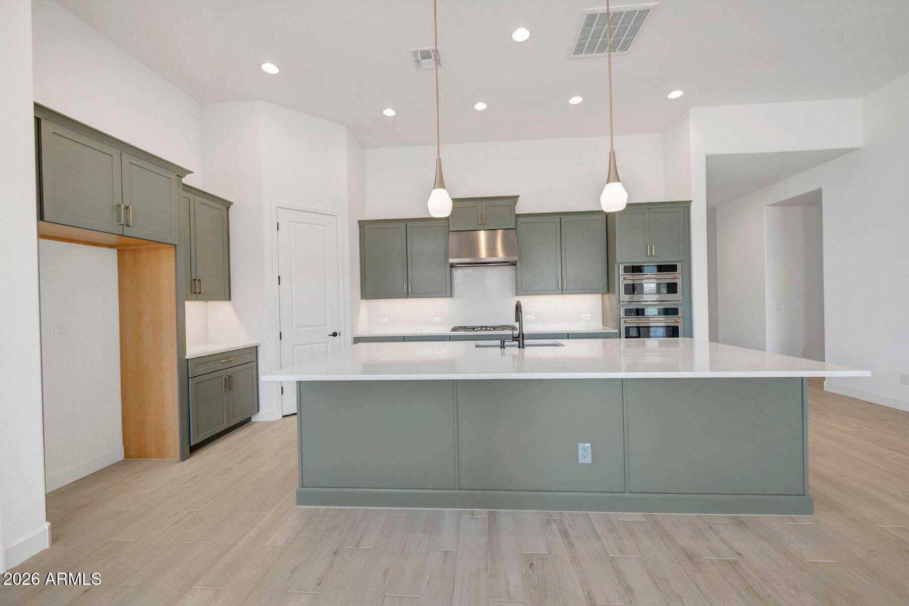 BRAND NEW single level home with 4 bed, 3.5 bath, study and 3 car garage; all beds have large walk-in closets; 12; ceiling with cathedral ceiling in owner's bed, 8' doors, large energy efficient windows and 12' sliding glass door in family room exiting to extended covered living area and private backyard; chef's kitchen with modern upgraded cabinets, tiled backsplash, large quartz island w/accent lighting, stainless GE appliances including gas cooktop and walk-in pantry; upgraded plank tile flooring and upgraded carpet/tile throughout; added dining cabinets and utility cabinets with added sink; spa-like owner's bath with floor to ceiling super shower and added rain can showerhead; 2x6 CONSRUCTION AND EXTENSIVE NEW HOME WARRANTY.