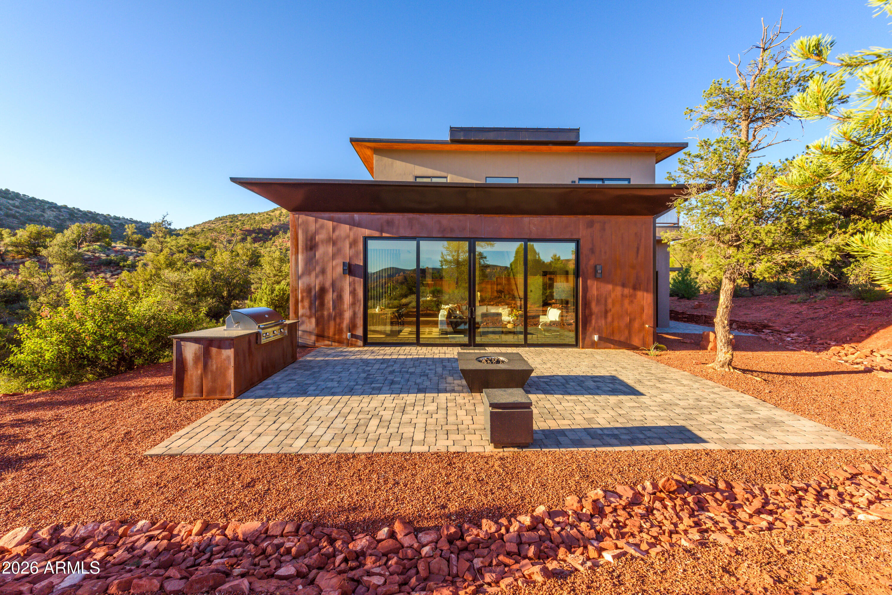 Stunning luxury home with unobstructed red rock views of Cathedral Rock in the prestigious Mystic Heights subdivision. Perched above Oak Creek and adjacent to National Forest, this 3,516 SF residence offers direct access to hiking trails and a rare blend of privacy, scenery, and convenience.
Situated on 1 acre, the home features 4 bedrooms, 5 bathrooms, and a 4-car garage. The open-concept floor plan is designed for seamless indoor-outdoor living, with expansive windows framing the surrounding red rock landscape.
The gourmet kitchen is equipped with top-of-the-line Thermador appliances, a large center island, and a custom walnut bar:ideal for both everyday living and entertaining. The primary suite offers a private outdoor retreat with hot tub & cold plunge. Upstairs, a spacious view deck captures panoramic red rock vistas. The outdoor terrace includes a built-in BBQ and gas firepit, creating an ideal setting for enjoying Sedona sunsets.

Located within walking distance to Oak Creek and nearby trail systems, and just minutes from Red Rock State Park, dining, shopping, and cultural amenities including the Sedona Performing Arts Center. High-speed Quantum Fiber internet (approx. 2GB per second download speed and close to 2 GB per second for upload speed).