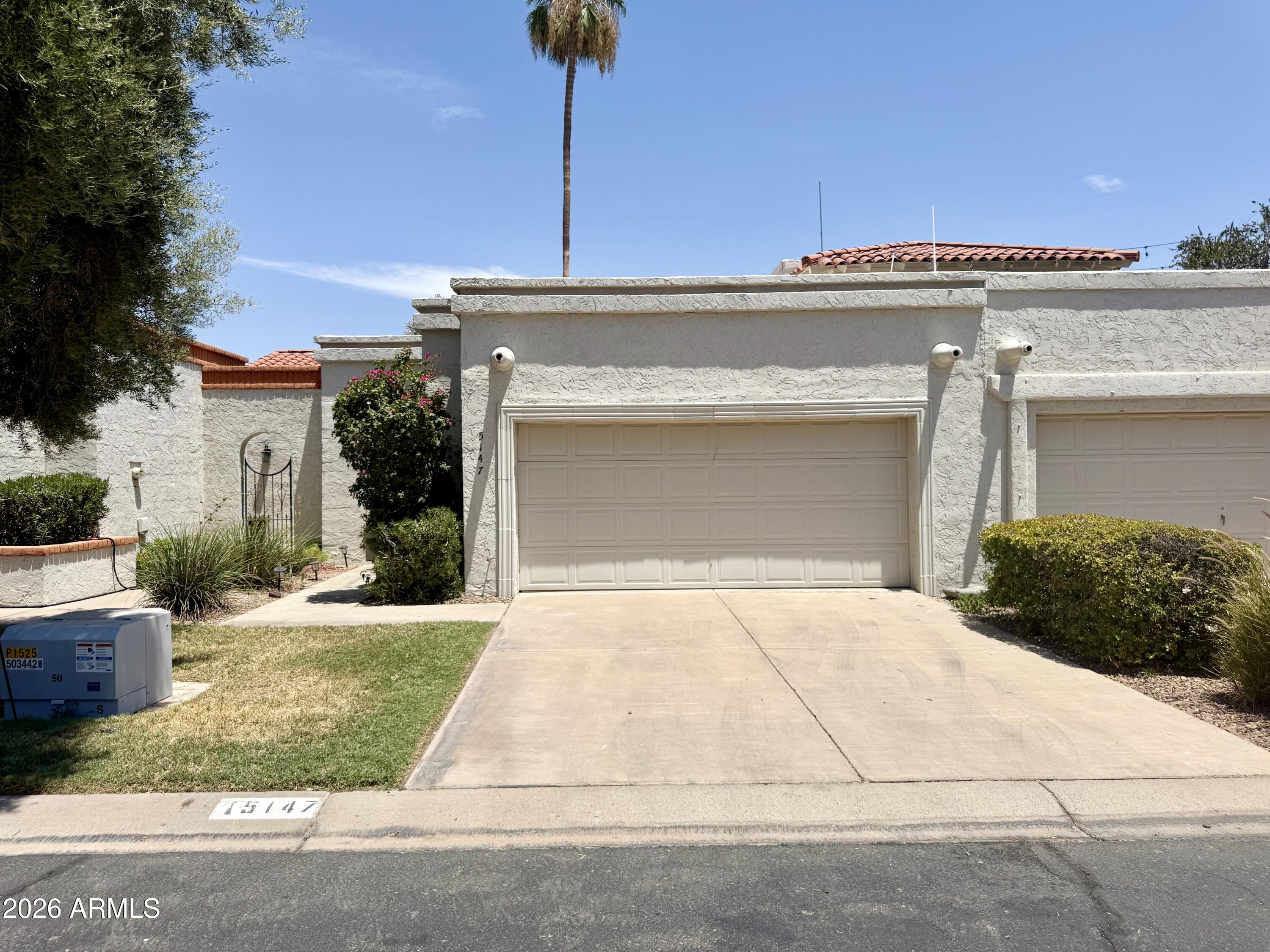 Experience the best of Scottsdale living in this beautifully maintained 2-bedroom, 2-bath townhome nestled in a quiet, desirable neighborhood. Featuring soaring vaulted ceilings, a 2-car garage, wood laminate flooring throughout the main living areas, and carpet in the bedrooms, this home offers comfort and style. The kitchen boasts granite countertops and stainless steel appliances, while both bathrooms feature upgraded granite surfaces and cabinetry. The primary suite includes blackout blinds for added comfort. Relax on the spacious private patio with peaceful views of the heated community pool and spa, buffered by mature landscaping for added privacy. Minutes from Old Town Scottsdale, Fashion Square, Loop 101, dining, golf, spring training, and entertainment.