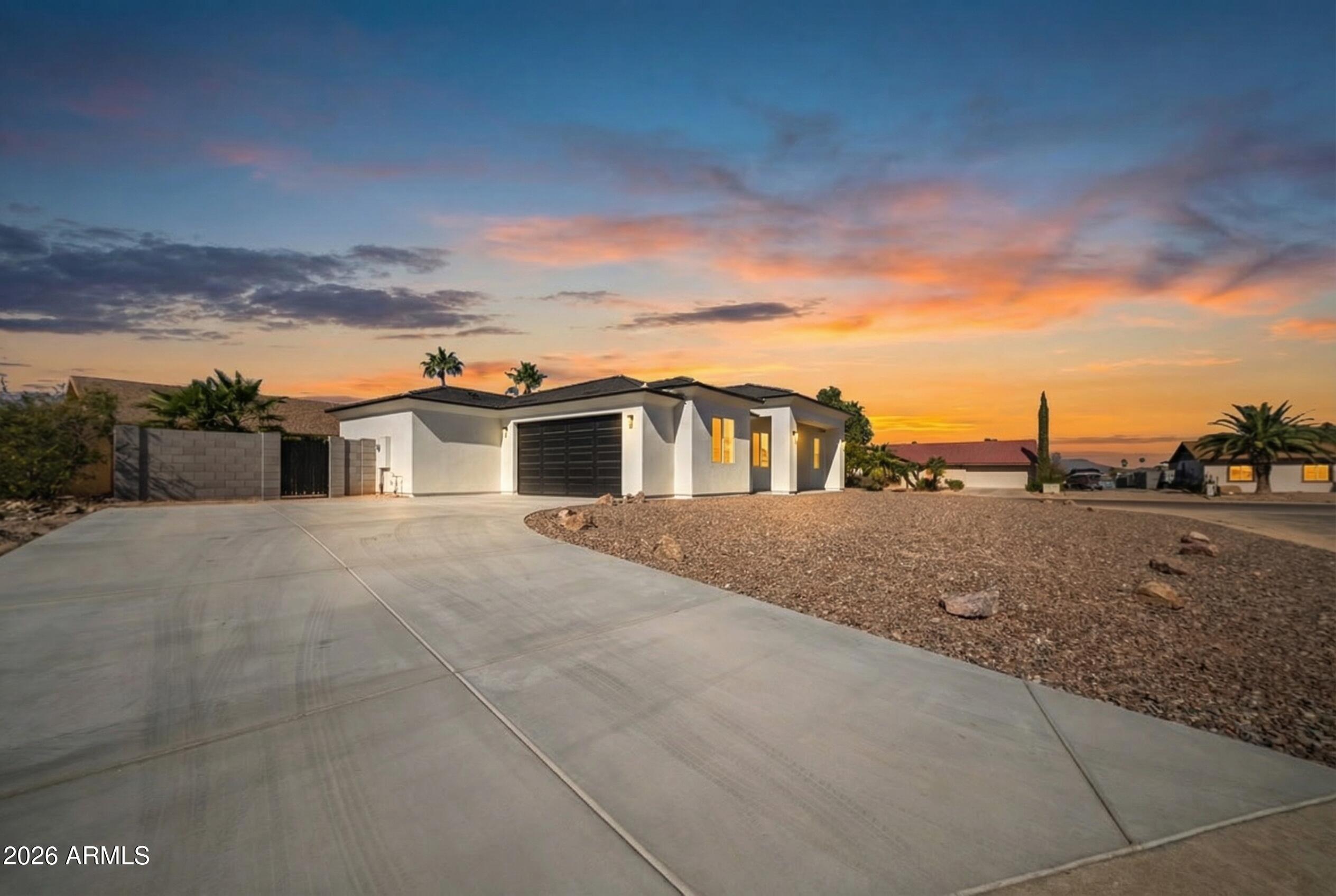 MODERN design meets PEACEFUL Arizona living! This SPACIOUS NEW BUILD not only qualifies for $0 DOWN but also features a bright OPEN LAYOUT with contemporary finishes and thoughtful details throughout.

Step inside to find WOOD LIKE TILE throughout, GRANITE countertops with a tasteful BACKSPLASH, a LARGE ISLAND, and a walk-in pantry, perfect for everyday living or entertaining guests. The split floor plan features a LARGE primary suite with DOUBLE vanity sinks and updated with TILE GLASS SHOWER and ELEGANT Light Fixtures! Situated on a CORNER LOT in a quiet CUL DE SAC, this home offers beautiful lake and mountain views, an 8,051 sq ft lot, block fencing for privacy with short PALM TREES, and a 2-car garage with additional parking. Within Minutes of Golfing, Dining, and Adventures from Hiking, Canoeing, or Biking!