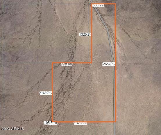 REDUCED! The perfect 60-acre slice of heaven nestled between two  mountains in Arlington, AZ! This is your chance to own a piece of the American Dream. Power is only a few miles away.  Except for a few neighboring parcels, you'll have this wide open wilderness all to yourself. Most of the surrounding land is state-owned, providing your peace and privacy. The roads to this paradise are not your average Sunday drive. You'll need an all-terrain vehicle to navigate the river beds you'll have to cross and forge your own trail part of the way. This property is located near the proposed Vermaland subdivision, making it a promising investment. While you're waiting for the wheels of development to turn, it's an excellent place to bring your family and friends for unforgettable getaways.